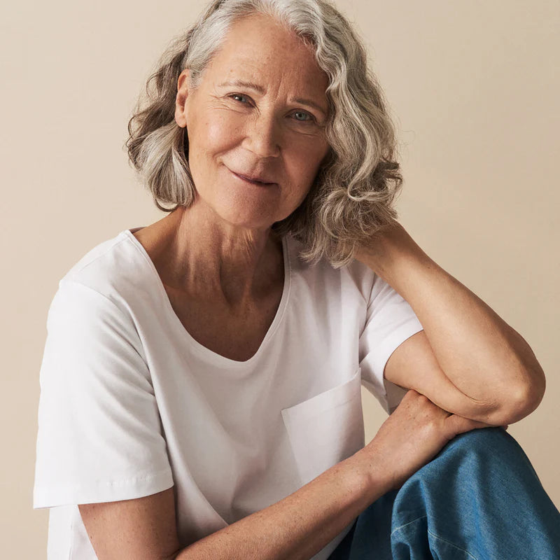 Nanso white t-shirt and blue jeans worn by woman