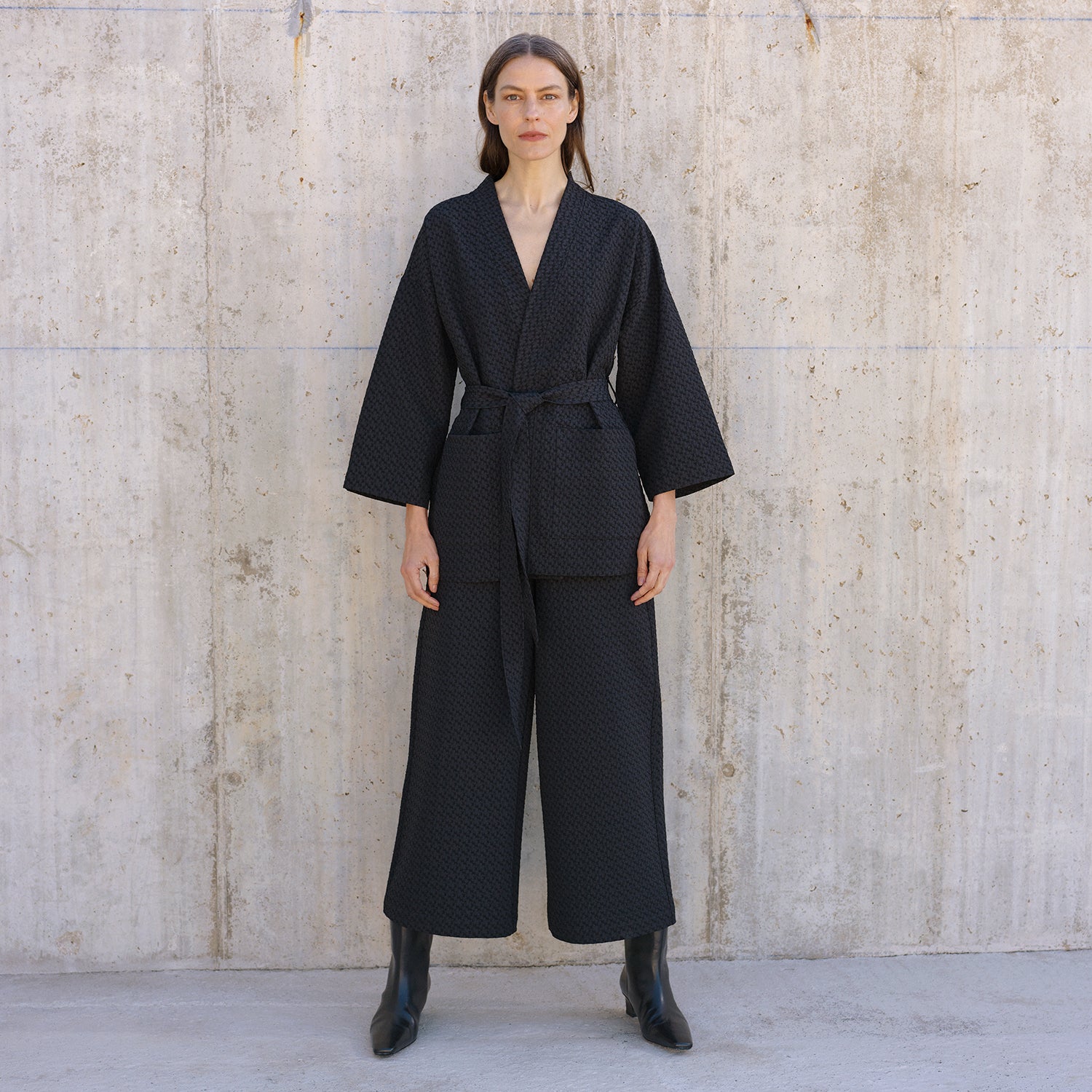 Nanso's elegant black Reliefi trousers in size 36 on a model, front