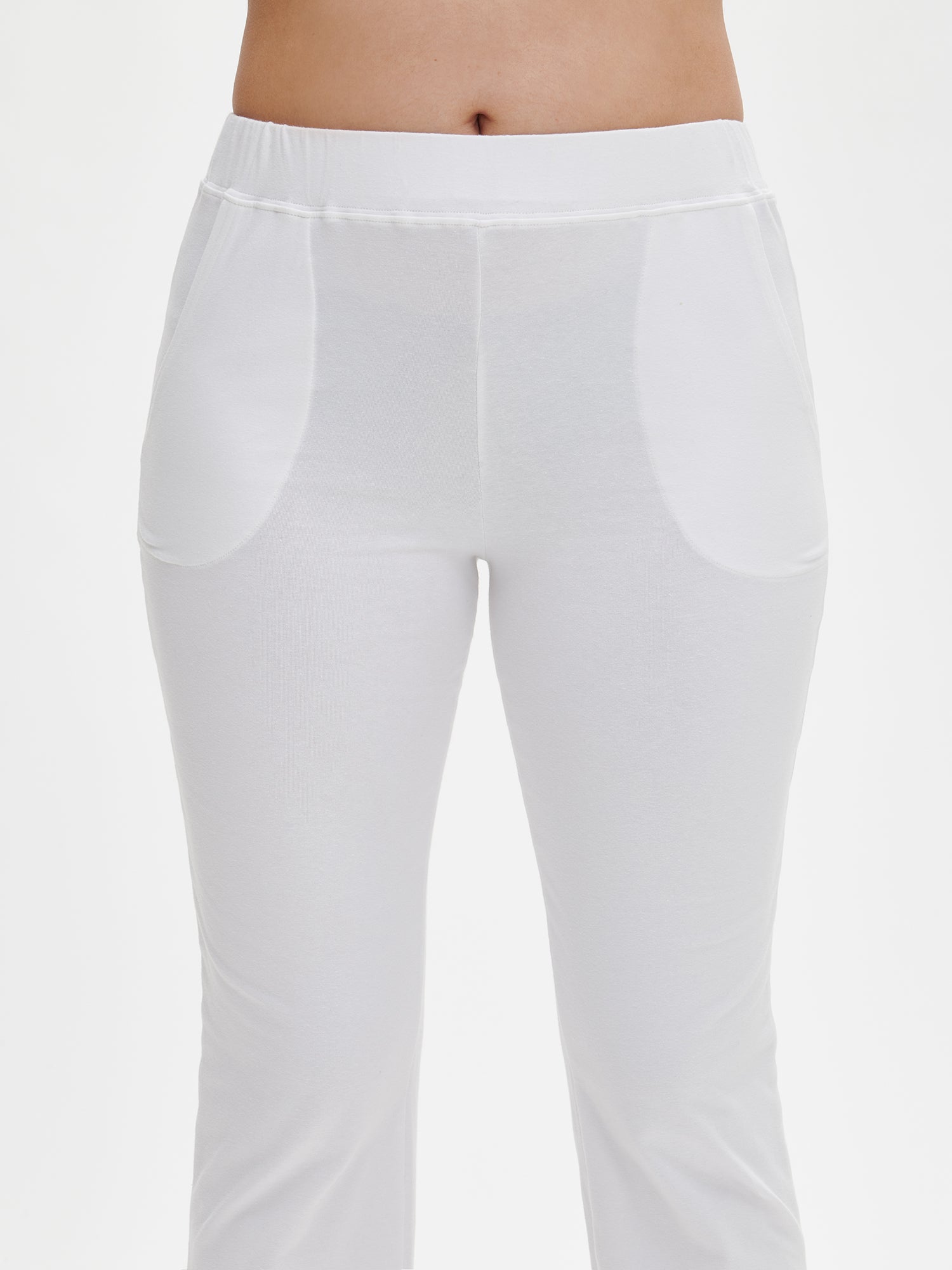 Women's Basic 7/8 jersey bottoms with a comfortable elastic band at the waist, side pockets and small side slits at leg openings. On a model, close-up.