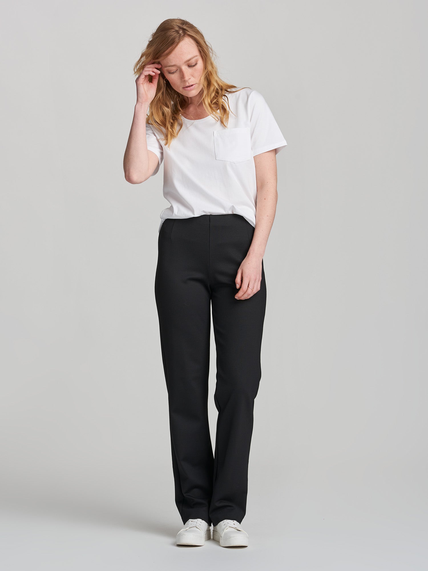 Nanso women's black Assi trousers on a model from front.