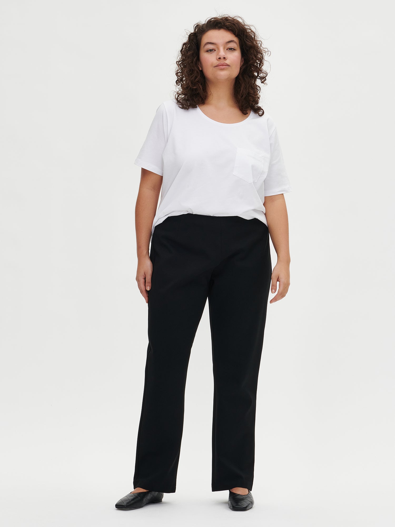 Nanso women's black Assi trousers on a model from front in size XL.