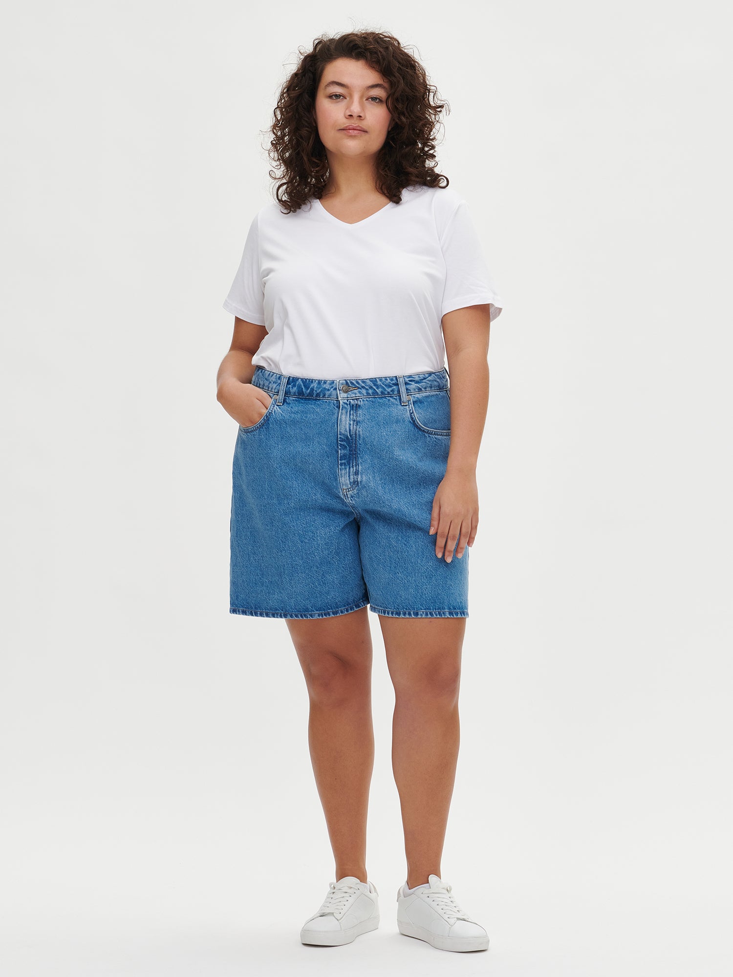 Women's Basic white T-shirt features a flattering V-neckline and comfortable short sleeves made from stretchy organic cotton-elastane blend, on a plus size model.