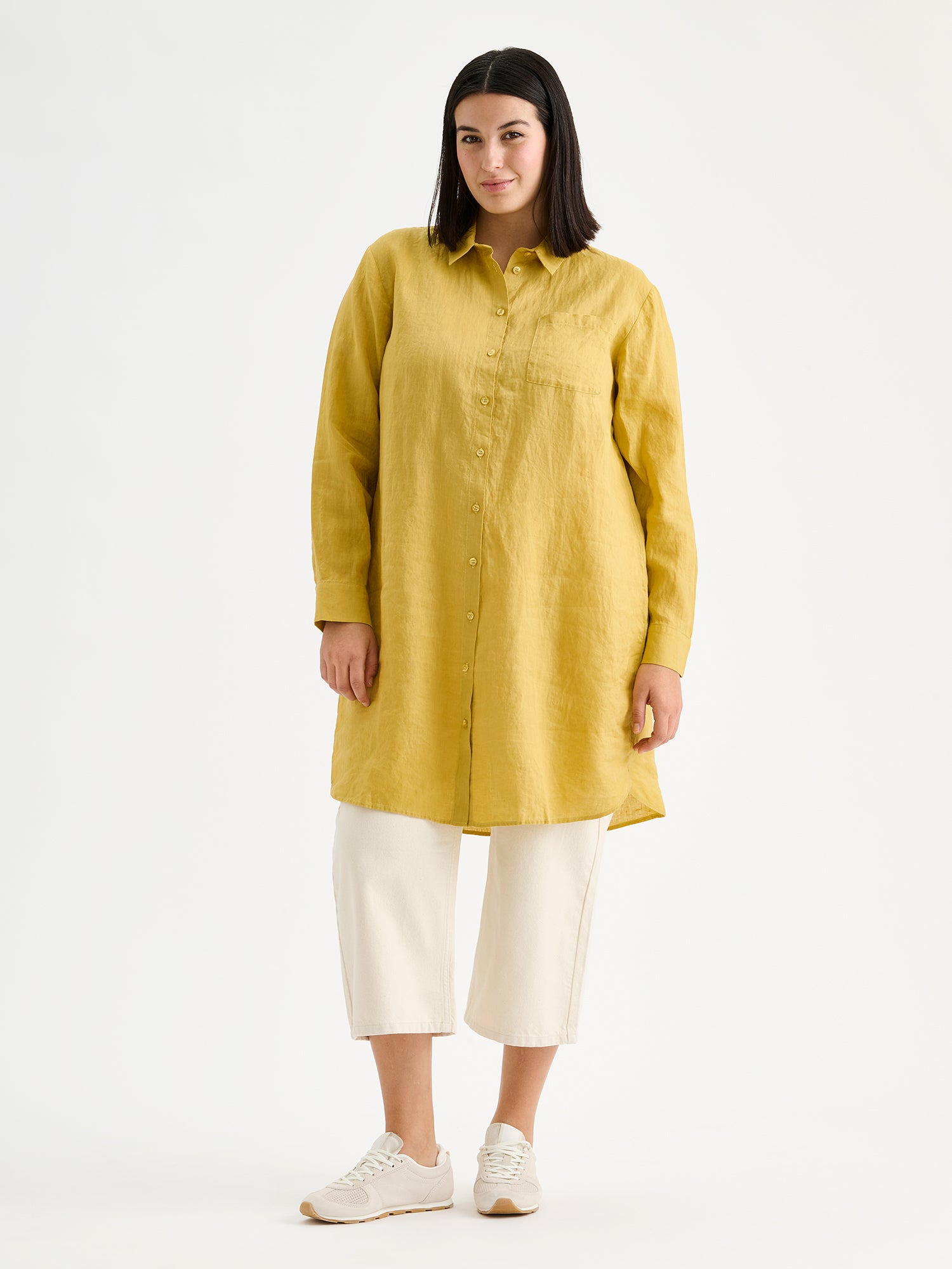 Nanso's long PELLAVA shirt in yellow on a model with off white jeans.