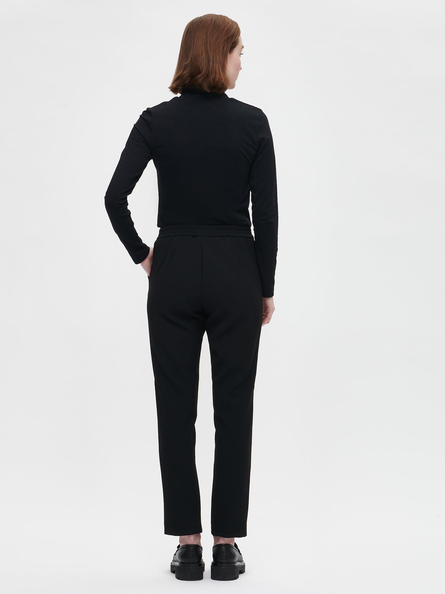 Nanso Women's black Tarina trousers, on a model from back.