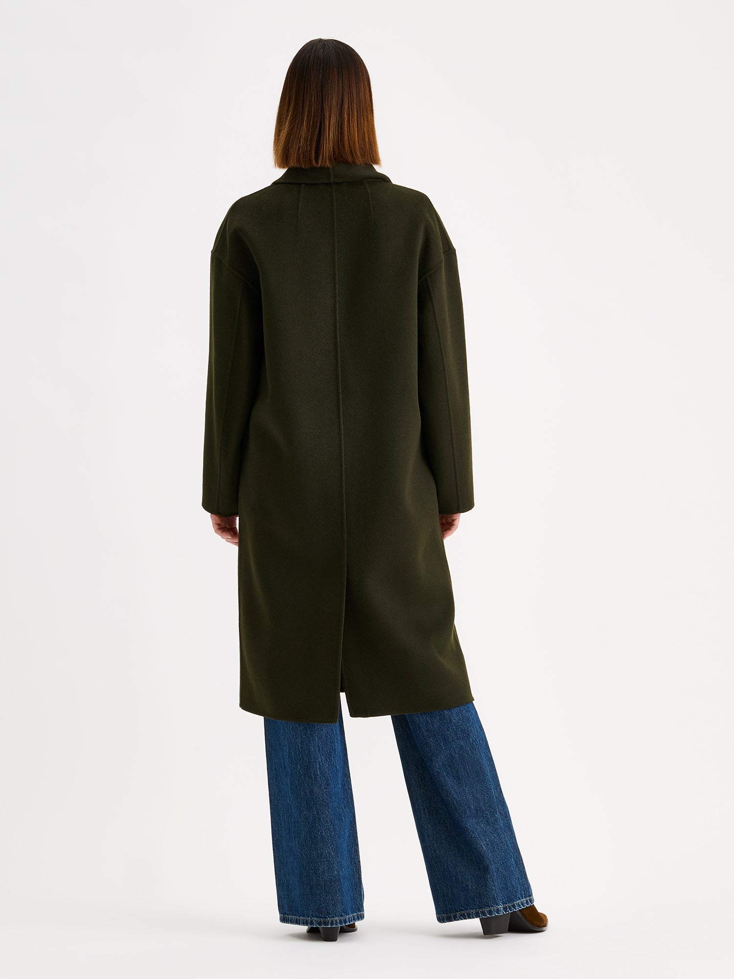 Nanso women's stylish and timeless olive green YLLE wool coat on a model with jeans, from the backside