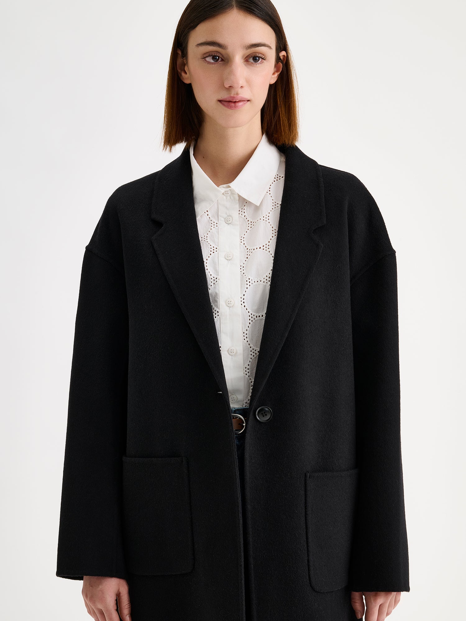 Nanso women's stylish and timeless black YLLE wool coat on a model with jeans and a white shirt | S - 173cm