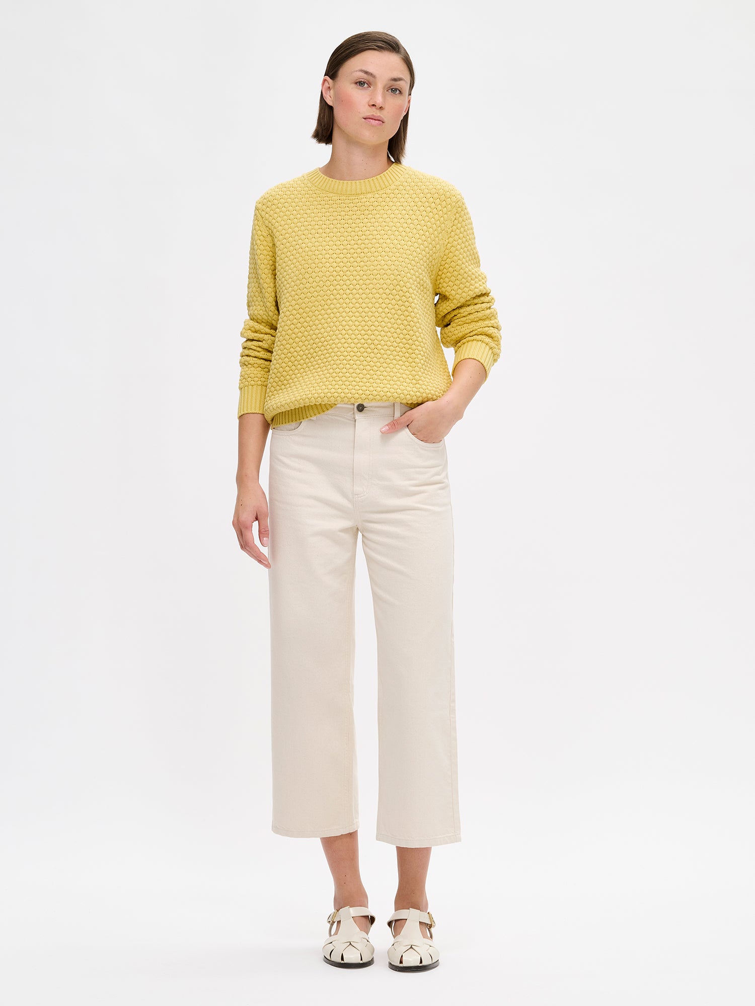Women's KUMPU Knit Sweater in yellow on a model with light jeans.