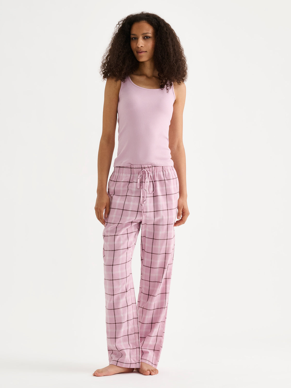 Nanso women's Heila ribbed top in a soft light lilac shade on a model with pink flannel pants. | S - 180cm