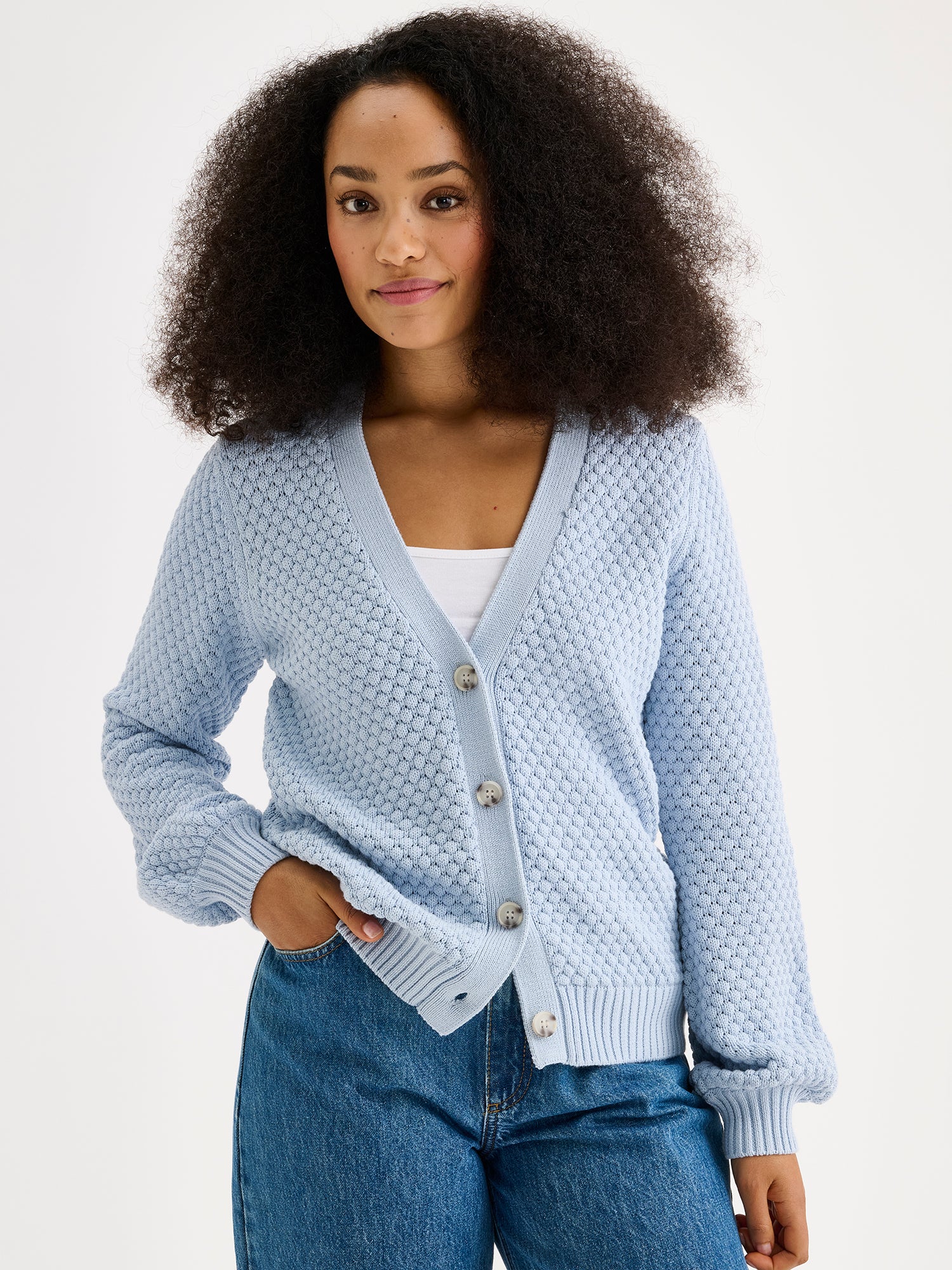 women's KUMPU Knit Cardigan in Light Blue on a model with jeans, close-up