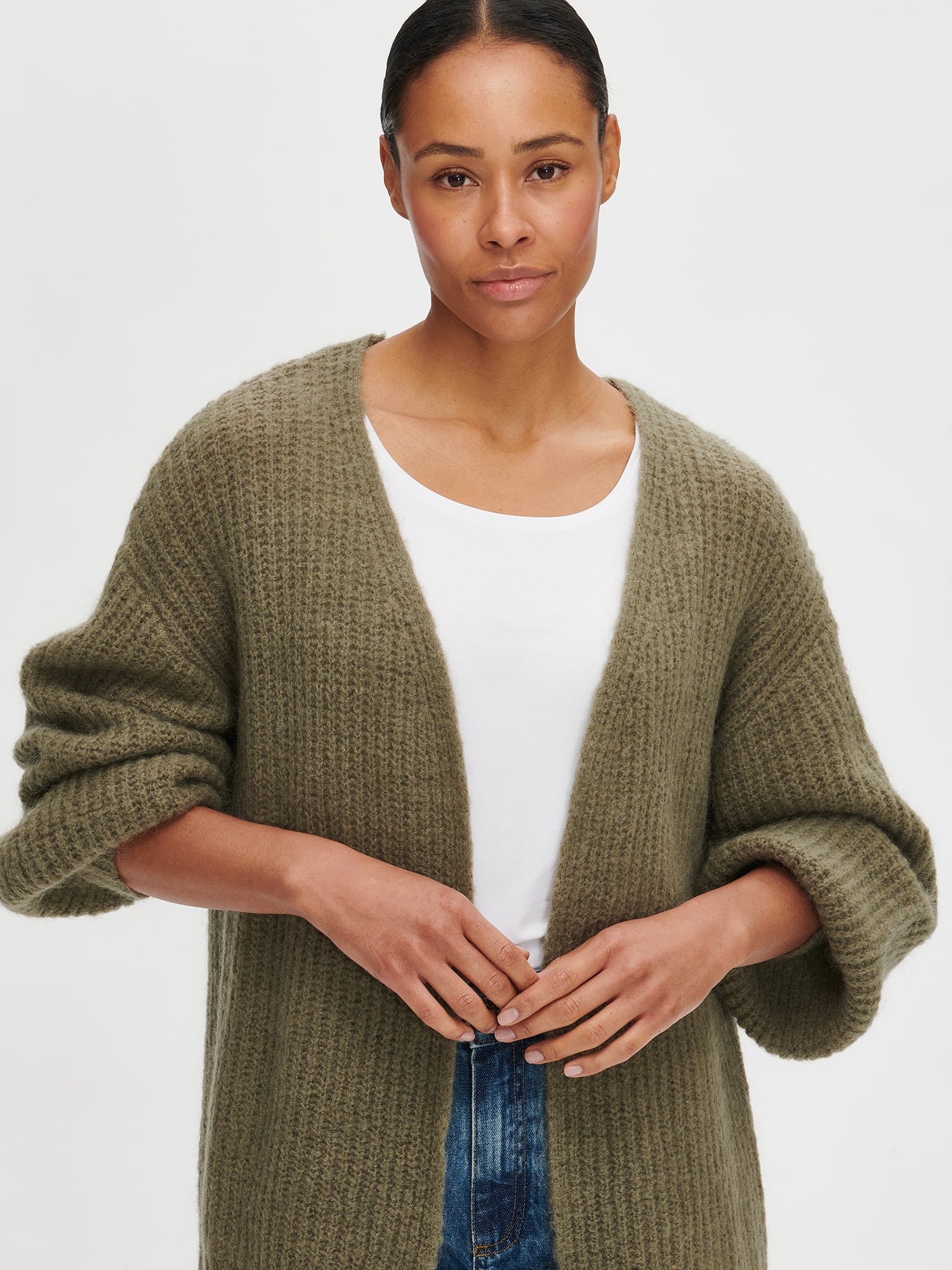 Nanso's women's luxurious olive green knit Karamelli cardigan, on a model