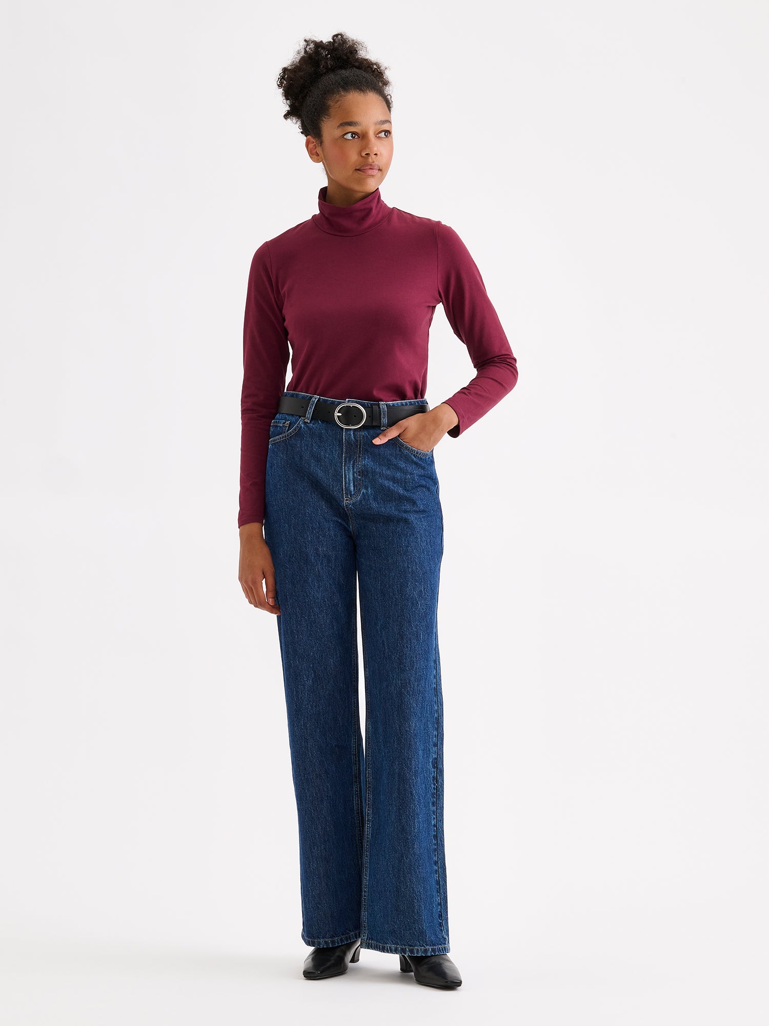 Women's Mari jersey turtleneck in wine red on a model with jeans
