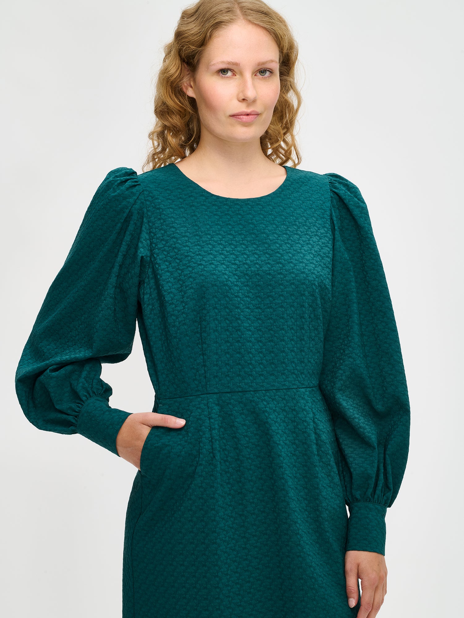 Nanso's elegant dark green Reliefi dress for women features a stylish design, close-up