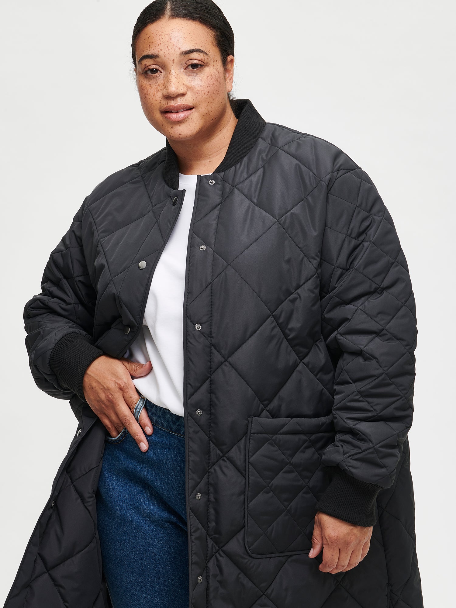 Nanso women's casual black Midi quilted coat on a model with jeans and a white shirt