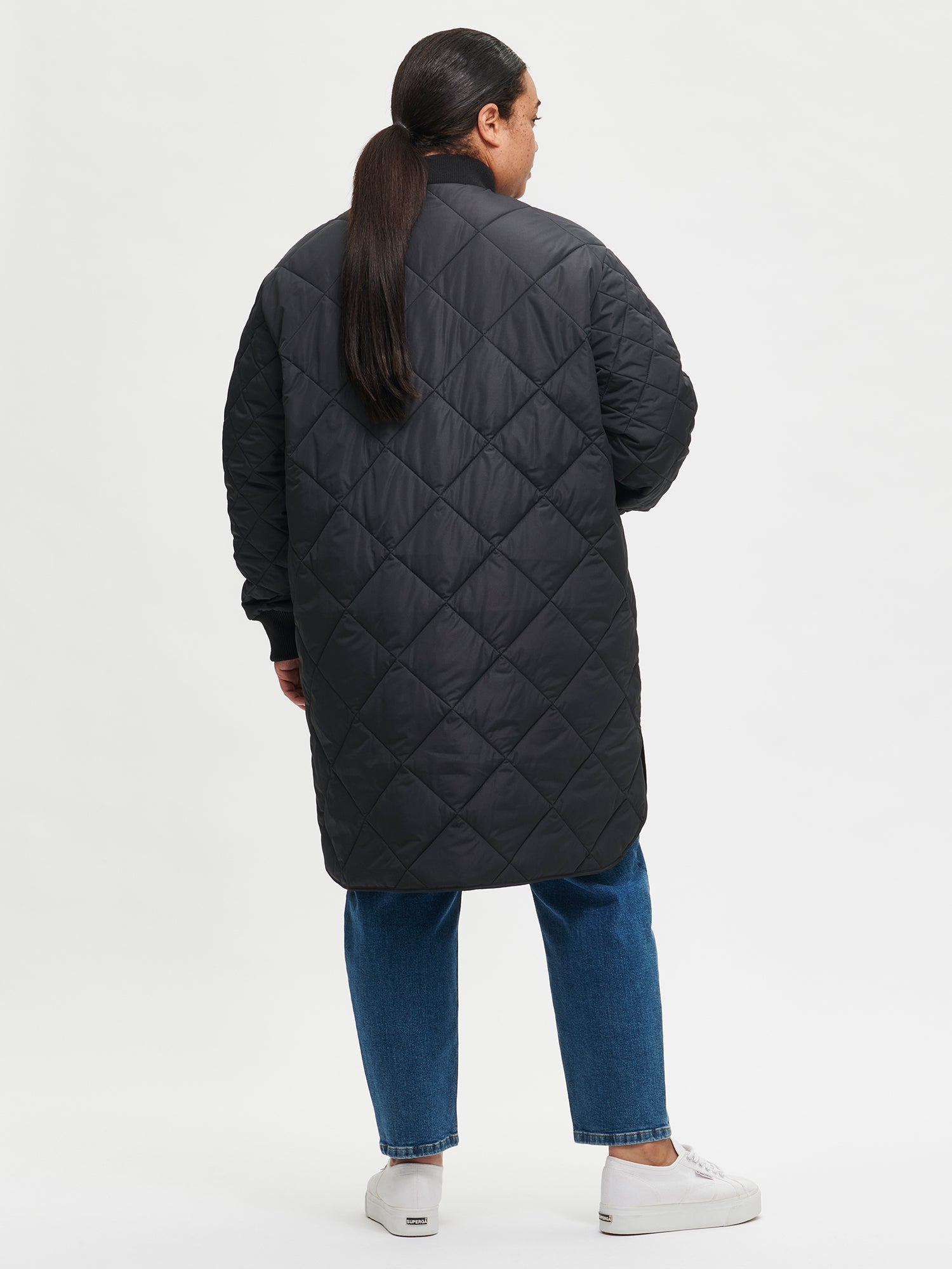 Nanso women's casual black Midi quilted coat on a model with jeans from the backside
