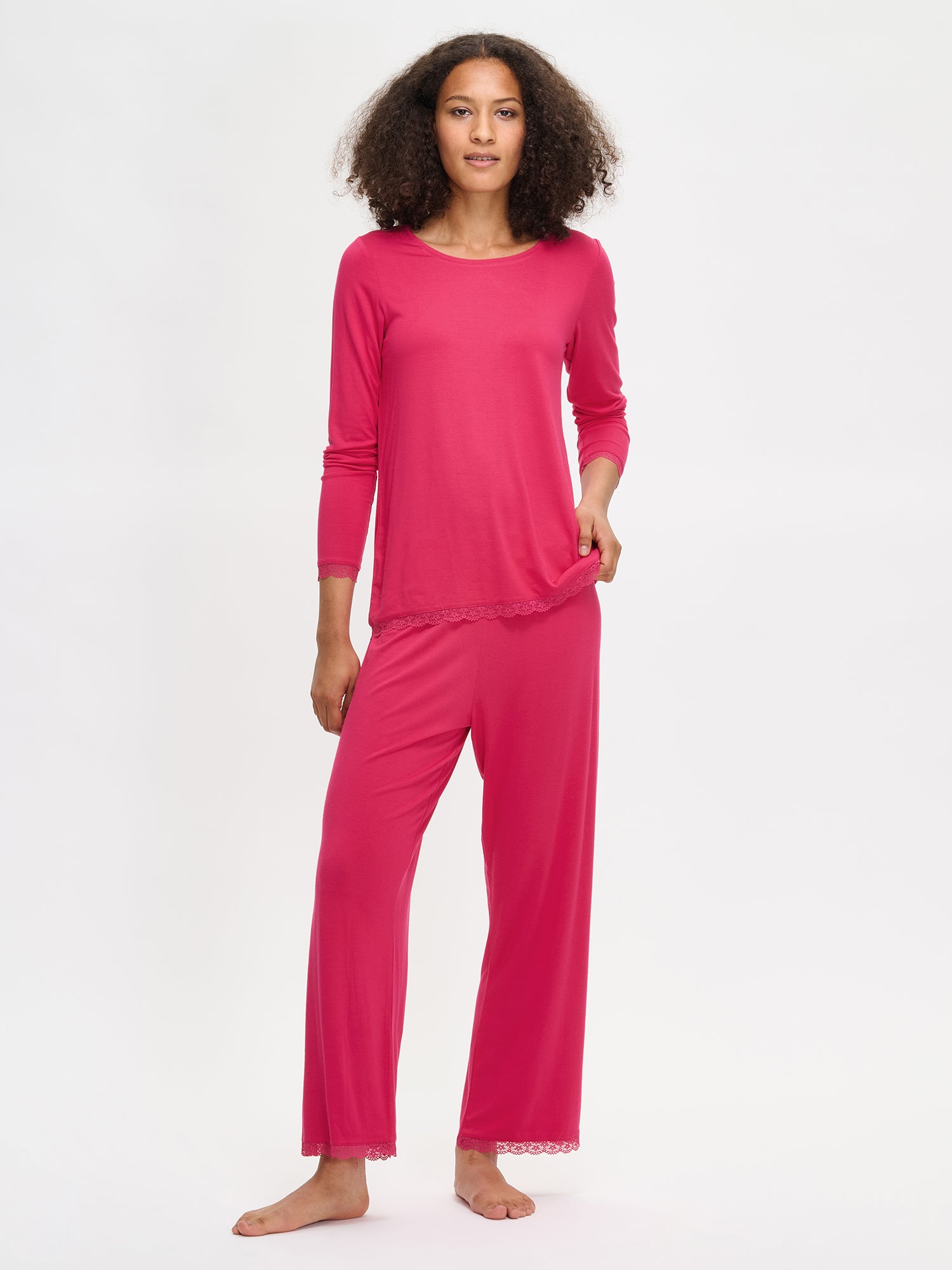 Women's pink Pitsi pants with pink Pitsi shirt on a model.