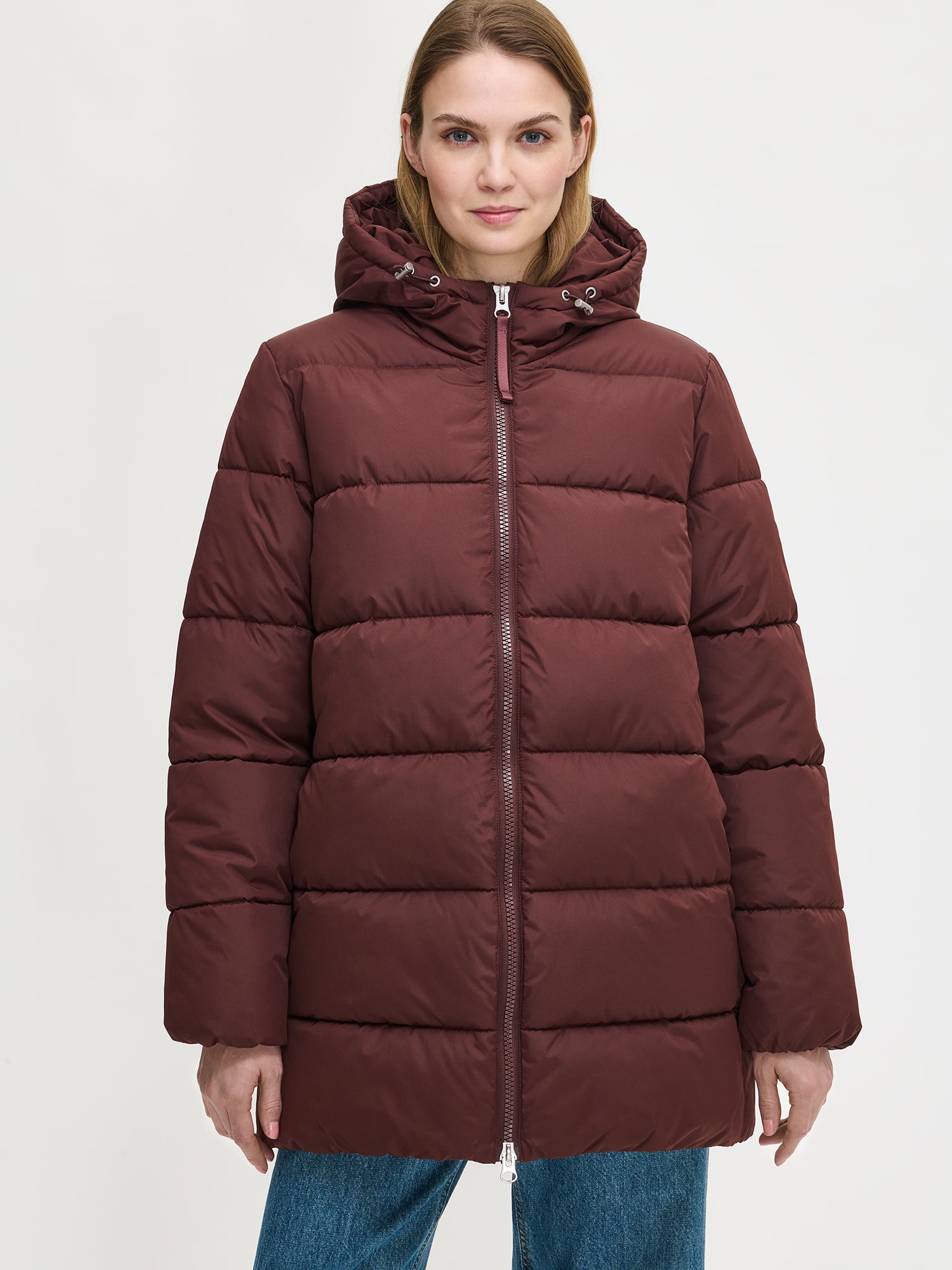 The dark brown Lumi padded coat provides warmth with its soft, lightweight padding and generous fit. From the front.