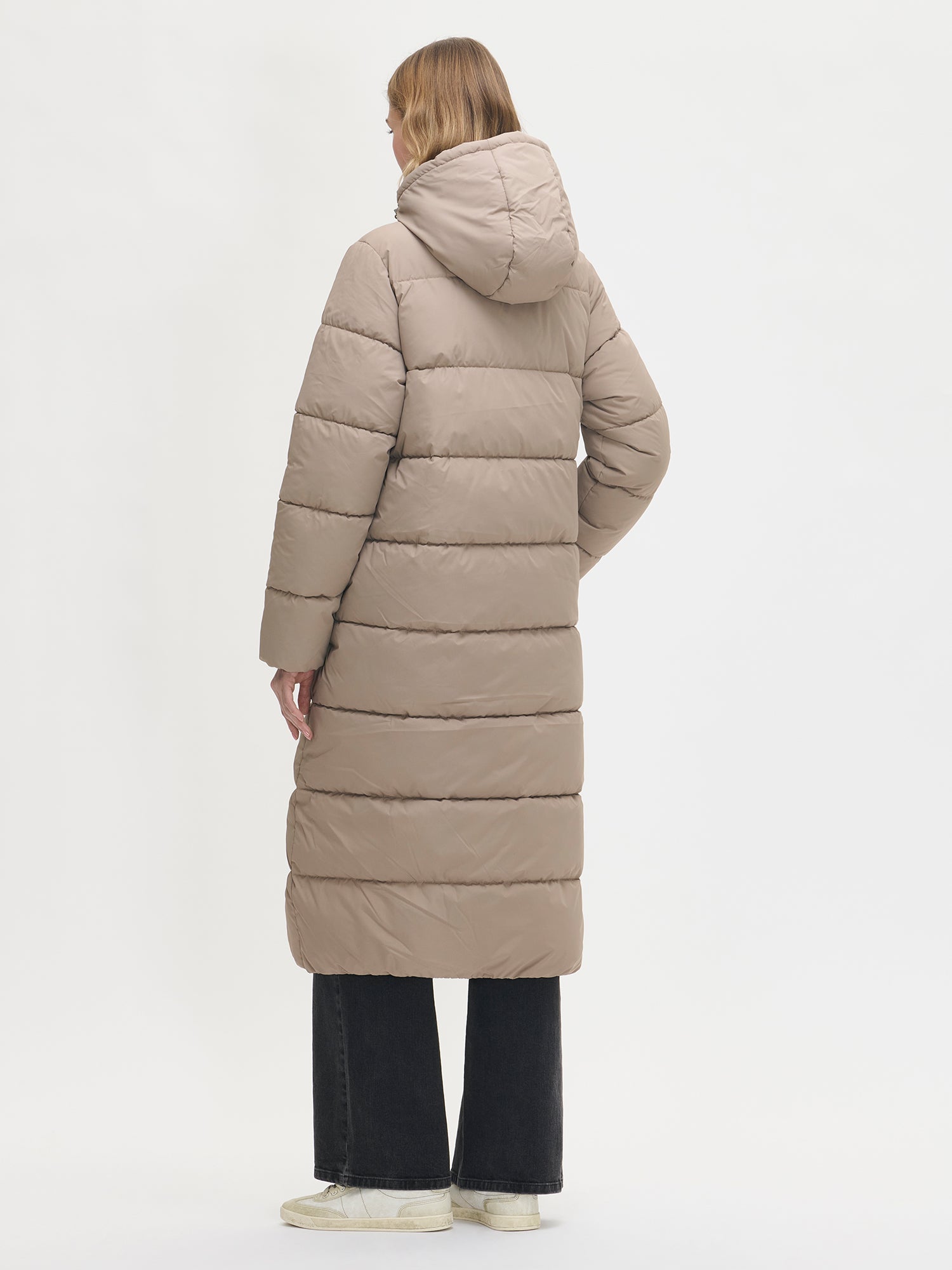 The Lumi Long Pink Puffer Coat in beige offers cozy warmth with its lightweight, puffy insulation. From the back.