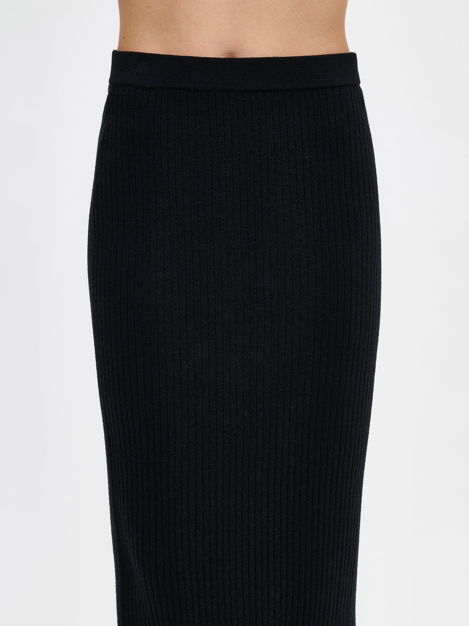 Black Villis ribbed knit skirt and sweater on a model, close-up