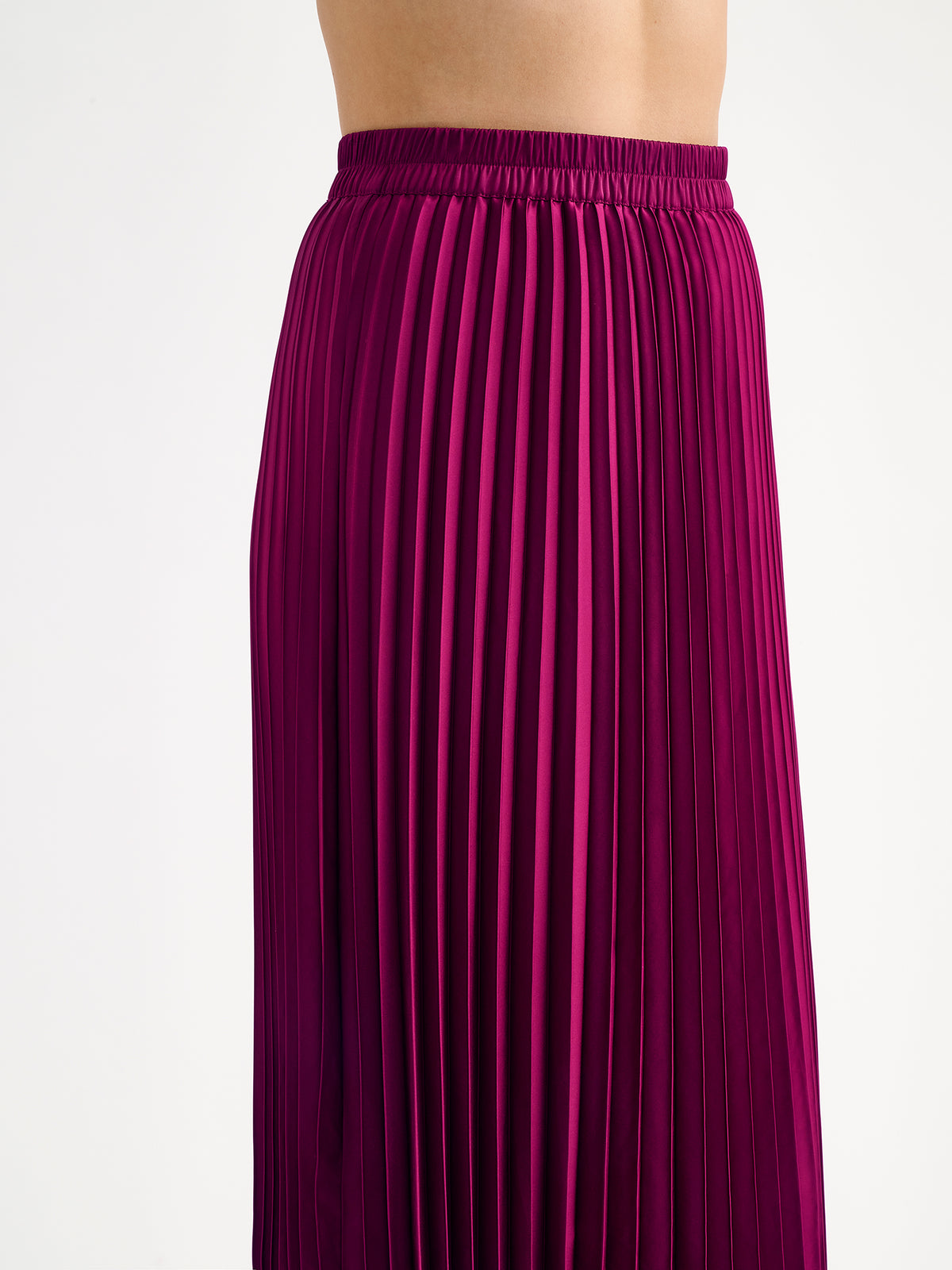 Nanso's elegant Taite skirt for women features a graceful drape in a vibrant violet shade, on a model close-up.