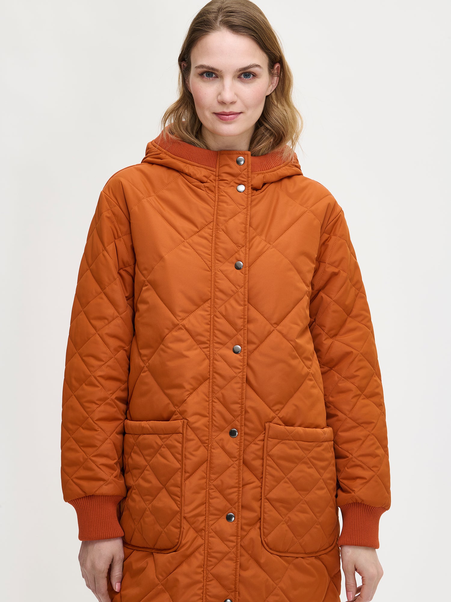Nanso women's casual brown Maxi quilted coat with light padding and a cozy hood, close-up