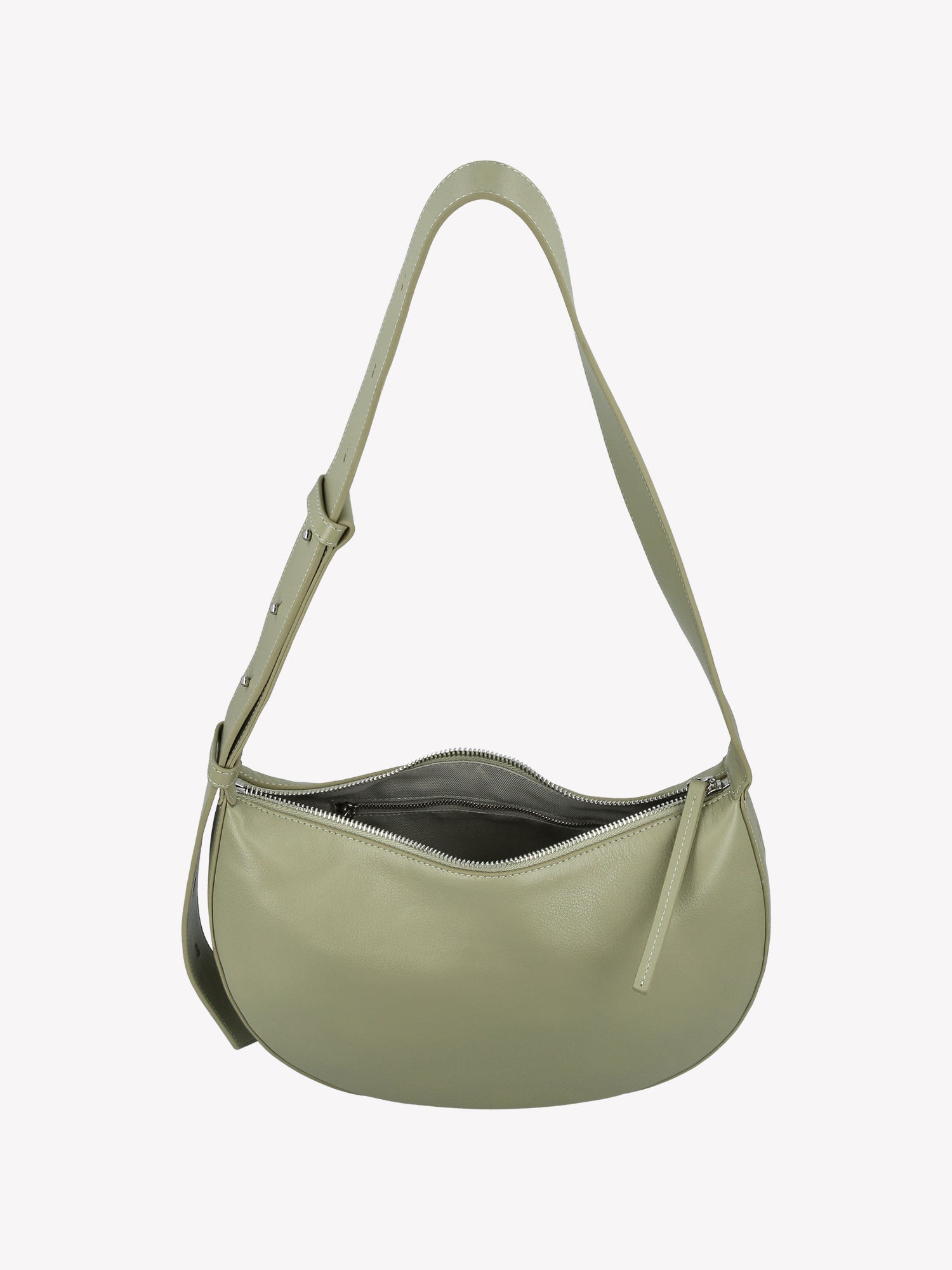 Nanso OLKA KUU - half moon-shaped leather shoulder bag in light green. Crafted with a sleek silhouette and practical zip closure and a comfortable shoulder strap. Product picture from the above, showing the inside of the bag.