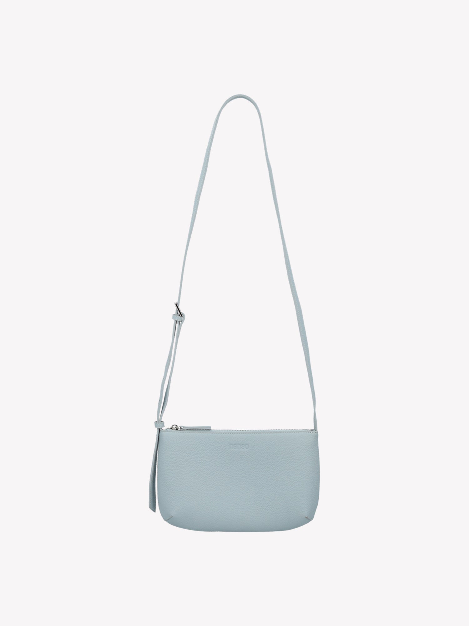 Nanso sleek light blue Naru leather bag comes with a long, adjustable shoulder strap and a secure zip closure. Made from certified leather. Product picture from the front.