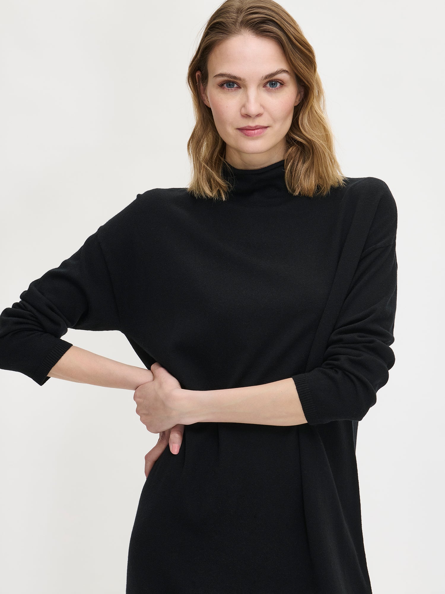 Women's Villis knit dress in black. Worn  by a model in size S, from the front.