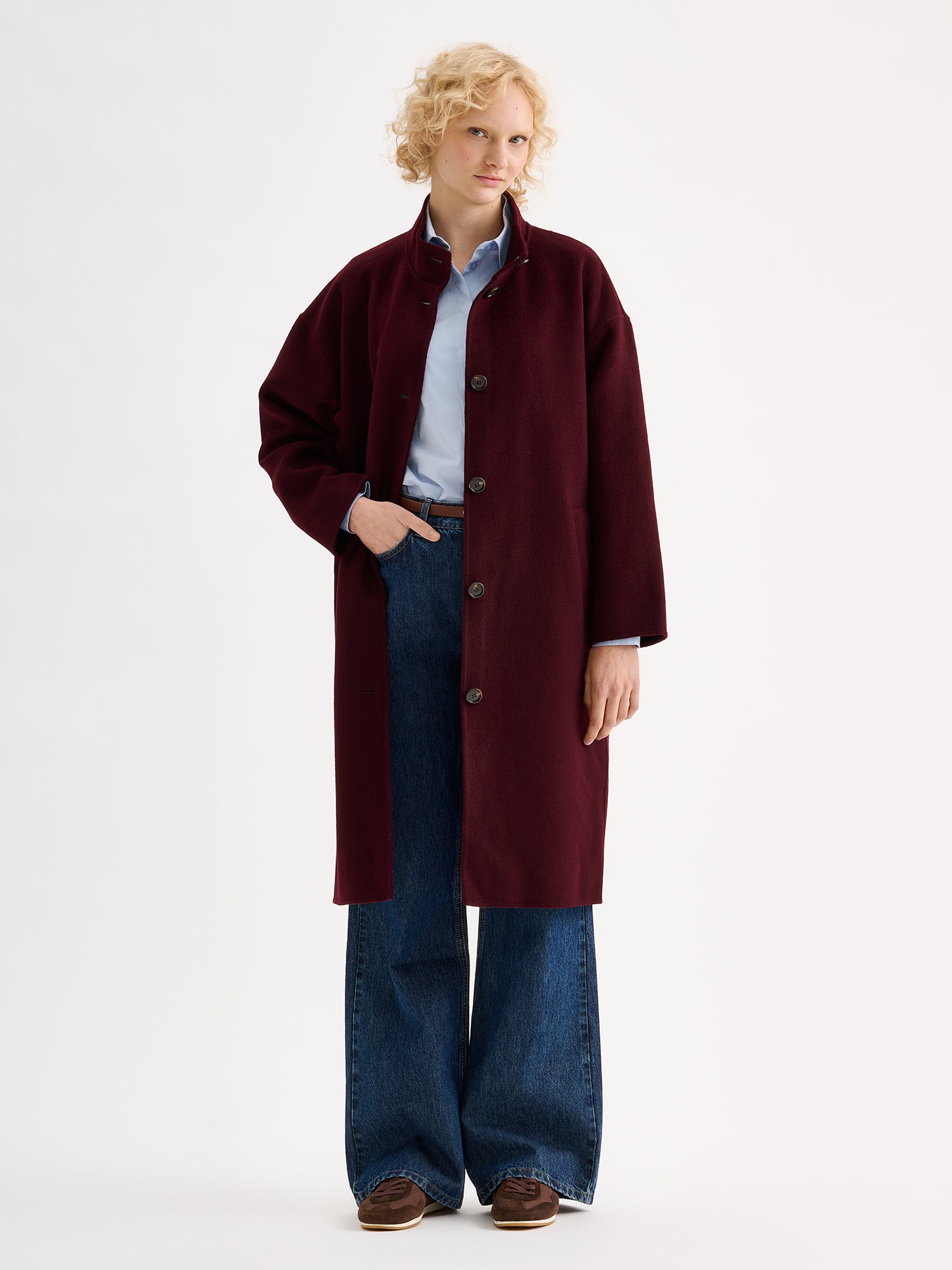 Nanso women's long burgundy Elle wool coat on a blonde model with blue jeans | S - 177cm