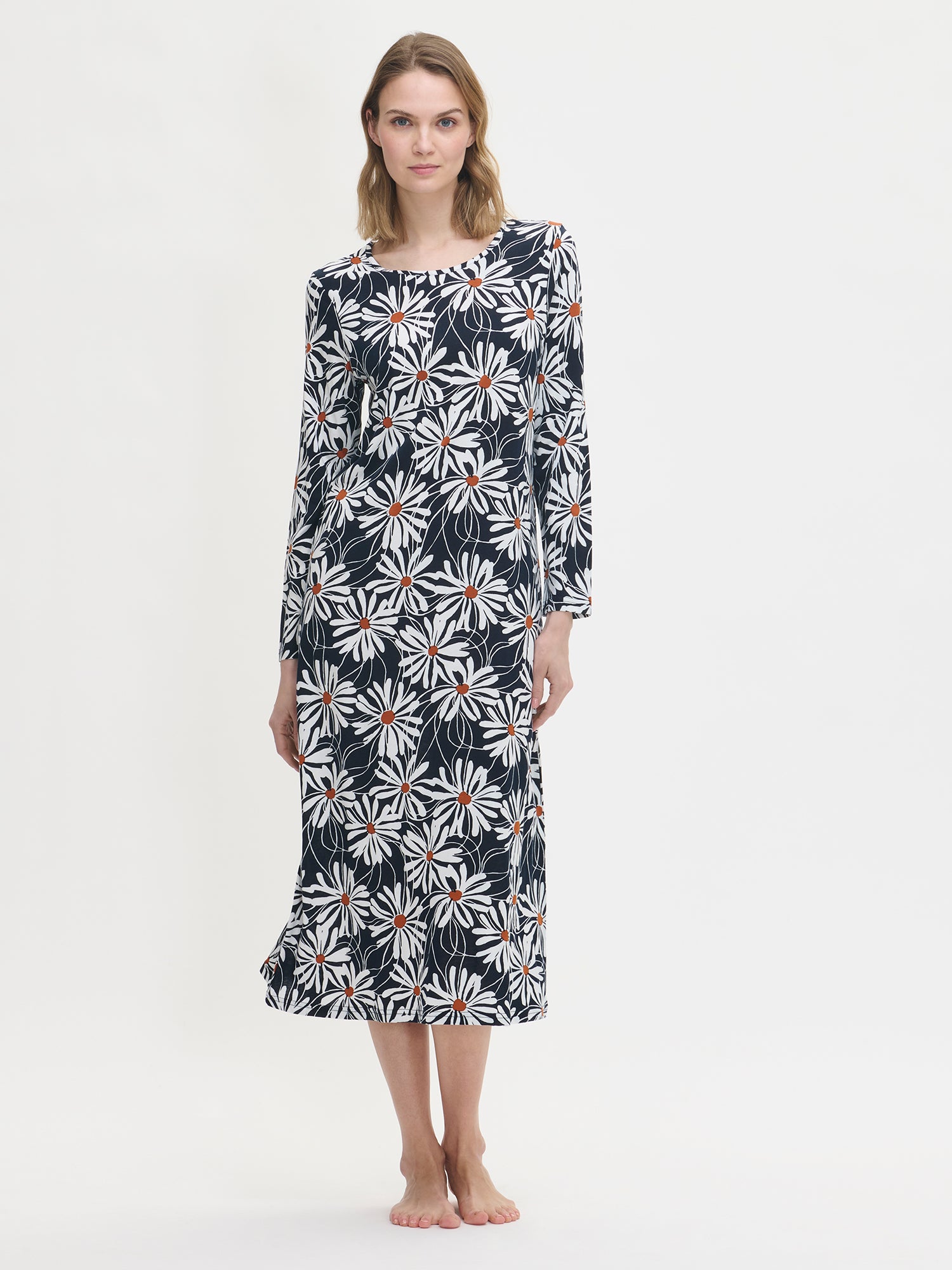 Women’s floral print Anette long nightgown with long sleeves in blue on a model from the front.