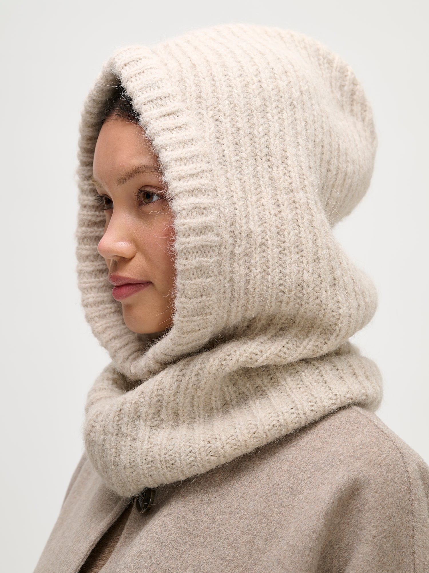 Nanso women's cozy beige Usva knit balaclava warmly covers both head and neck. side.