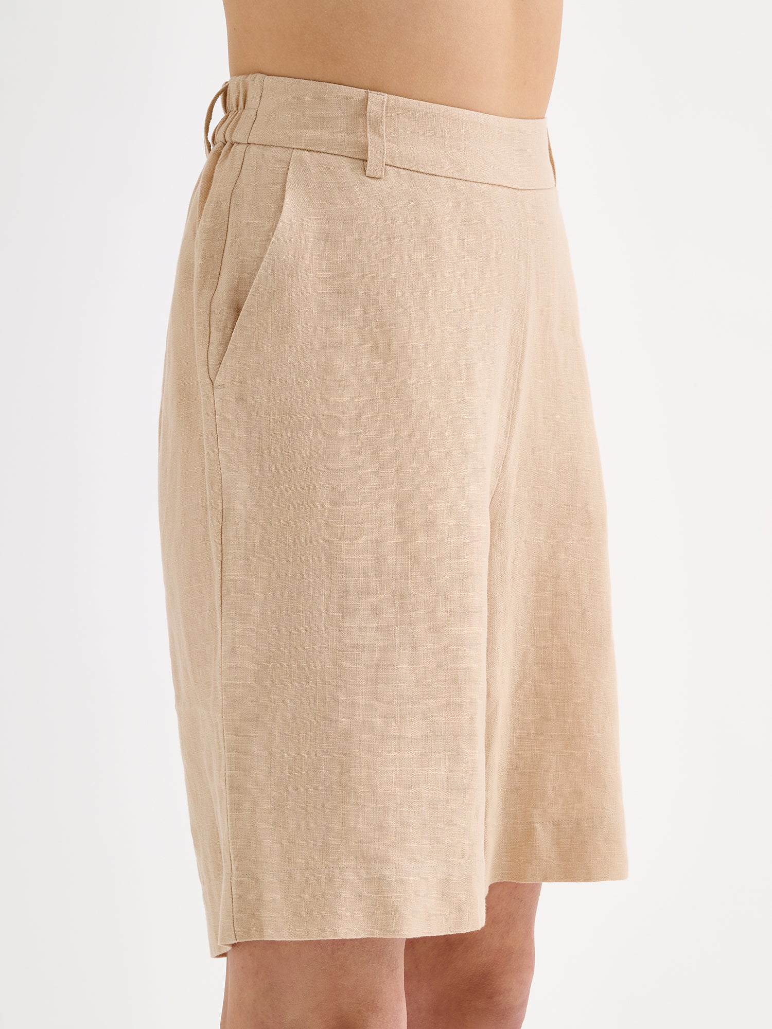 Nanso's classic beige Liine linen shorts for women on a model, close-up.