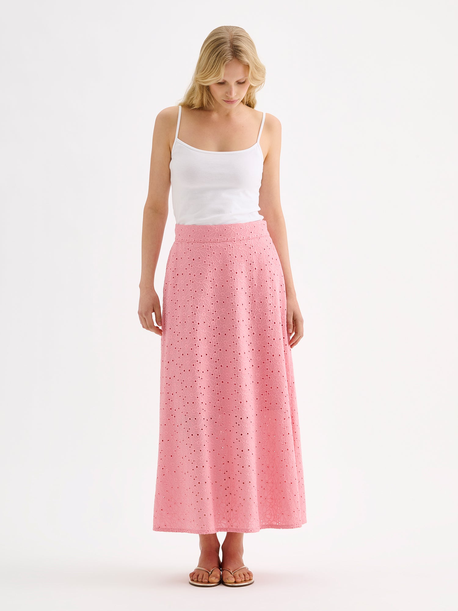 Nanso women's embroidered NUPPU Skirt in light pink featuring a broderie anglais style lace fabric on a model with a white top