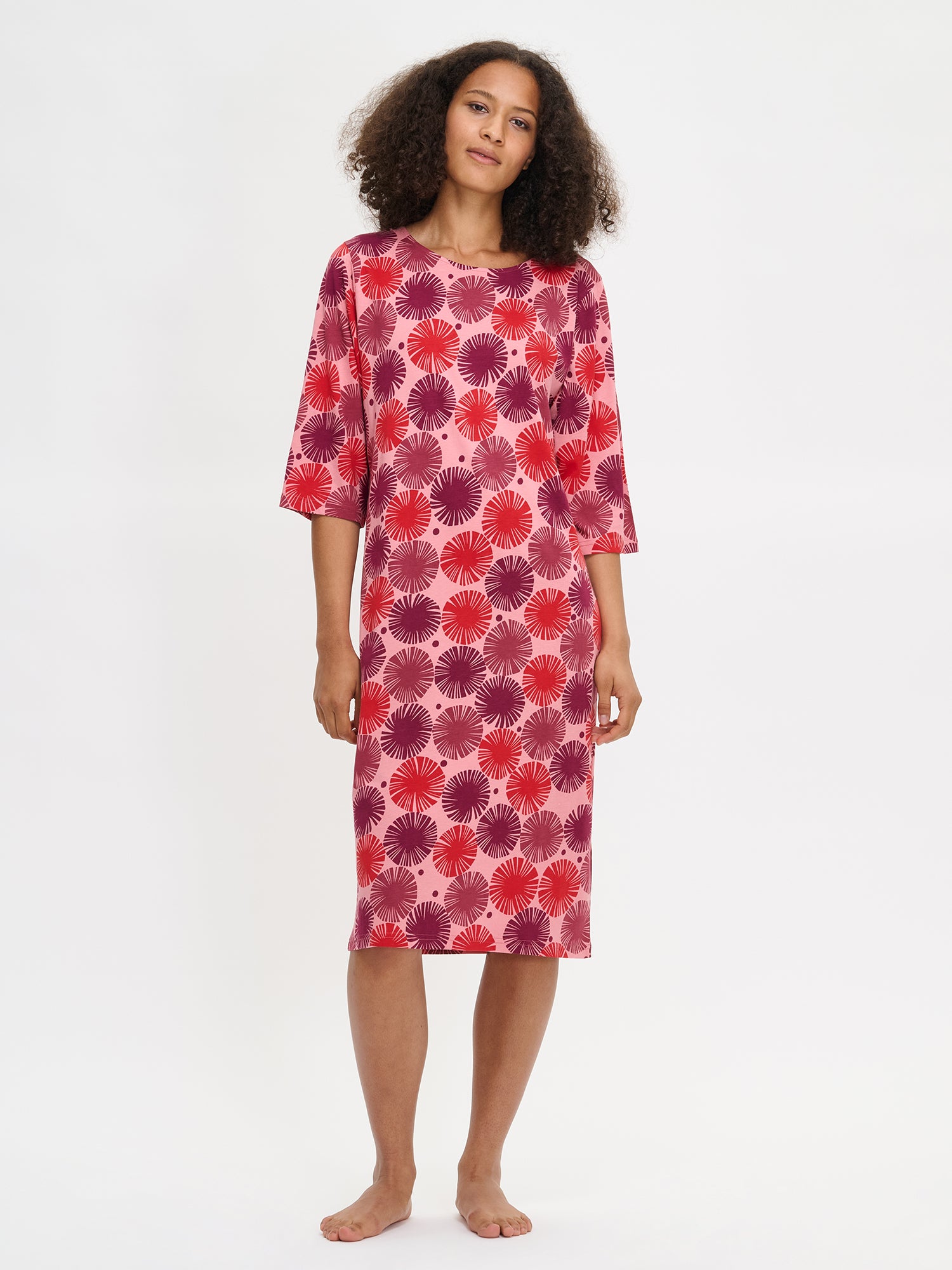 Nanso Amara red women’s pajama set with long-sleeved top in graphic print and solid full-length pants, worn by model.