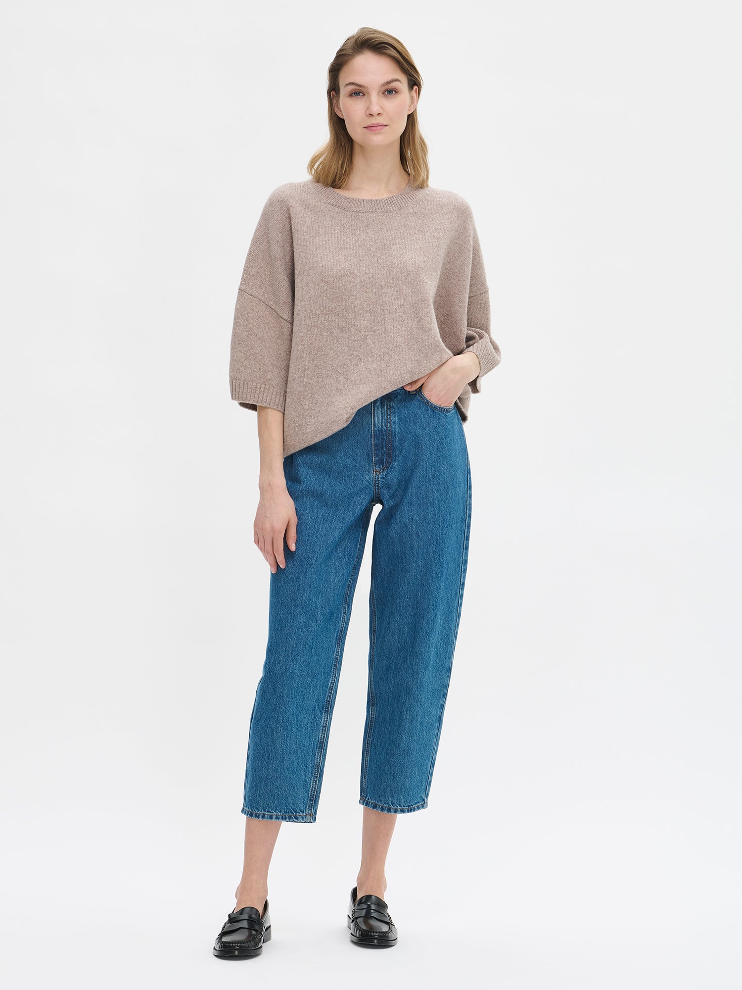 Women's Lana knit sweater in greige features relaxed, oversize silhouette, a classic crew neckline and 1/2 sleeves. On a model from the front.