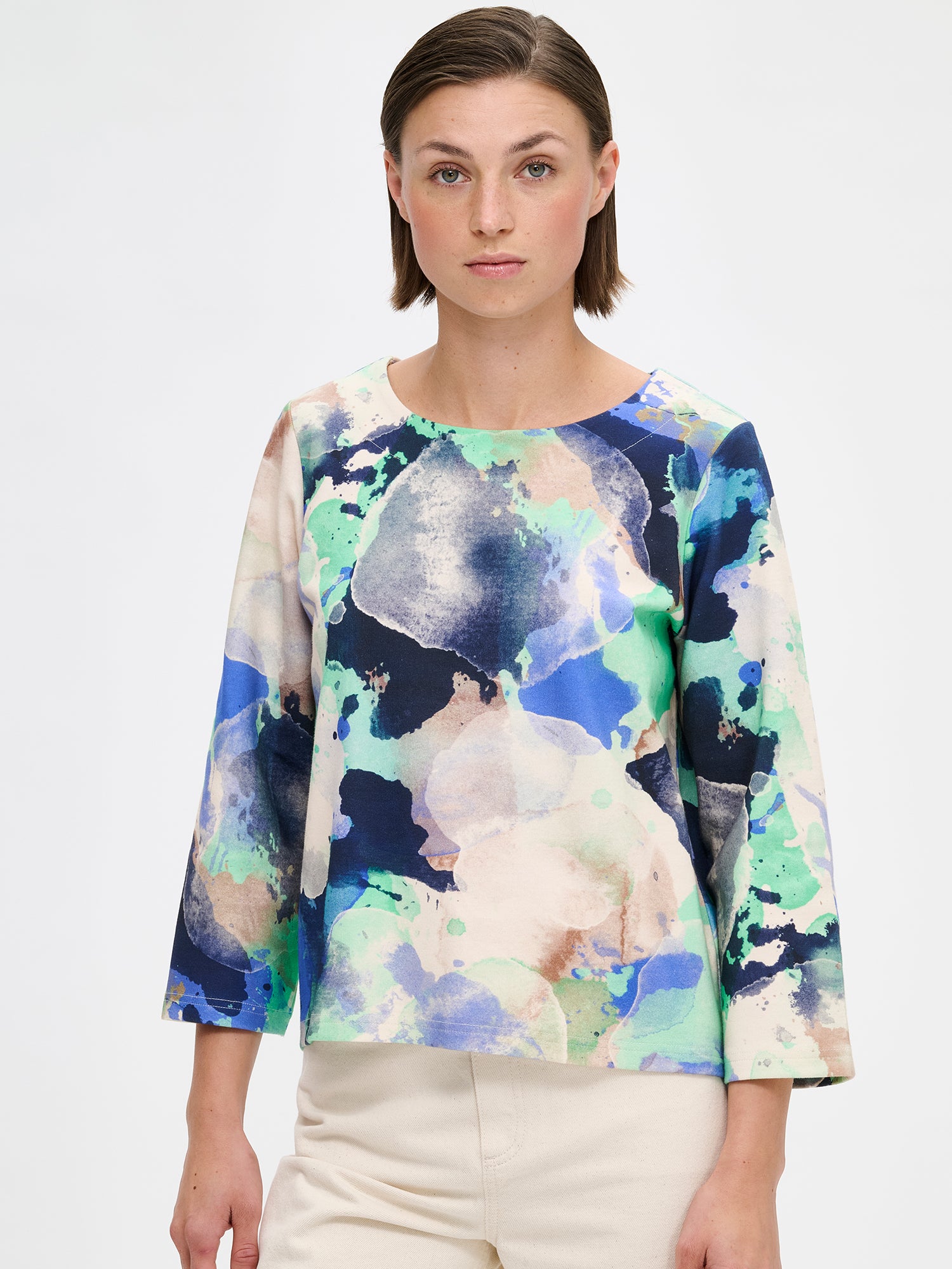 Women's SIRIUS Blouse features a beautiful abstract pattern and relaxed, boxy silhouette, a classic round neckline and 3/4 length sleeves. Pictured on a model, close-up