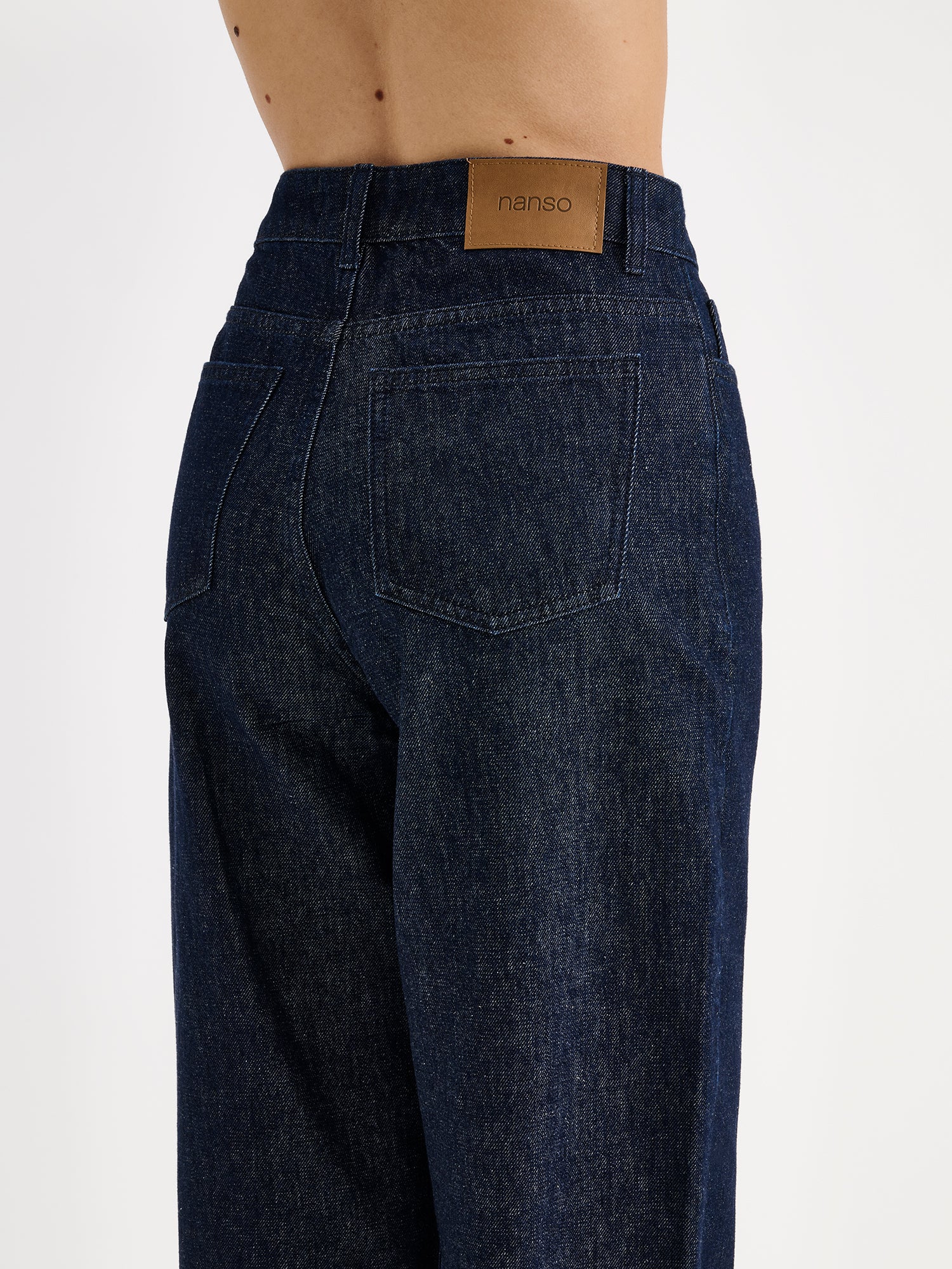 Nanso women's relaxed barrel leg Rento jeans in dark blue with an effortlessly comfortable fit, on a model close-up from the backside