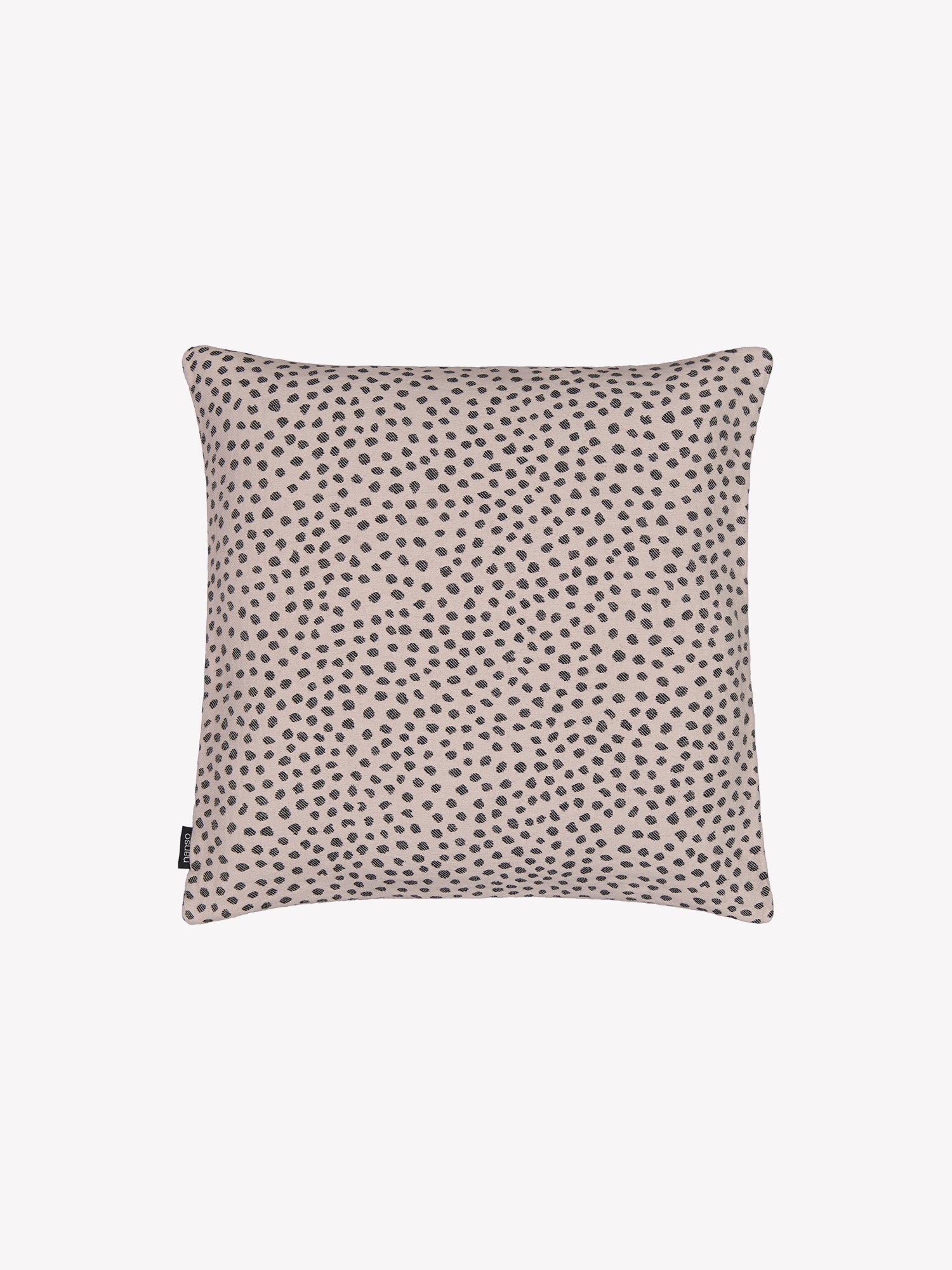 Beige Muru pillowcase with black polka dots in a product picture.