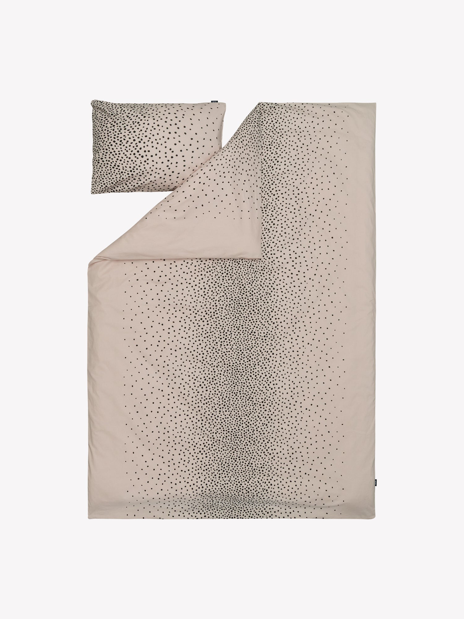 Täplä duvet cover set in a shade of rose with charming black dots opened in a product picture.