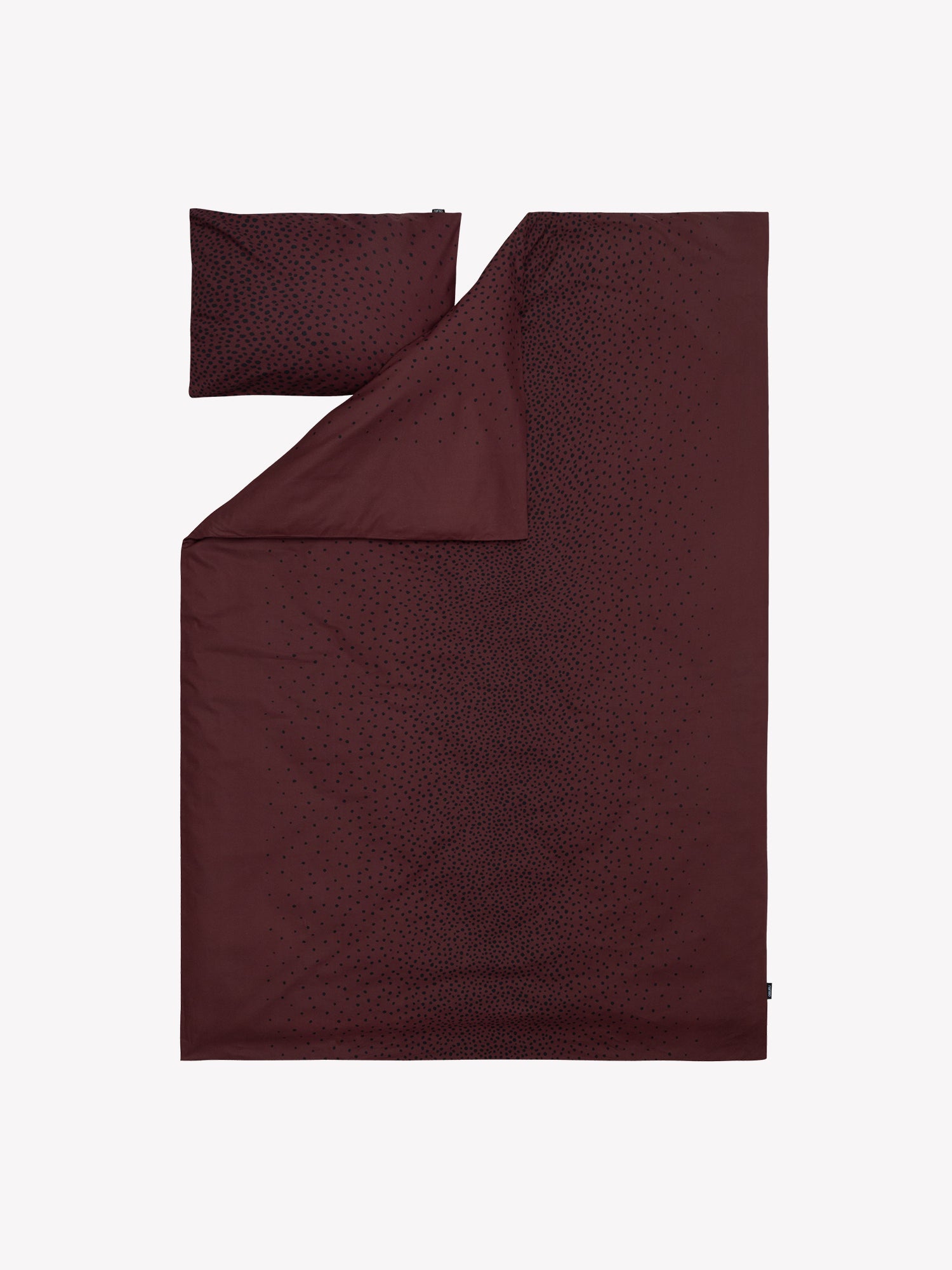 Täplä duvet cover set in brown with charming black dots opened in a product picture.