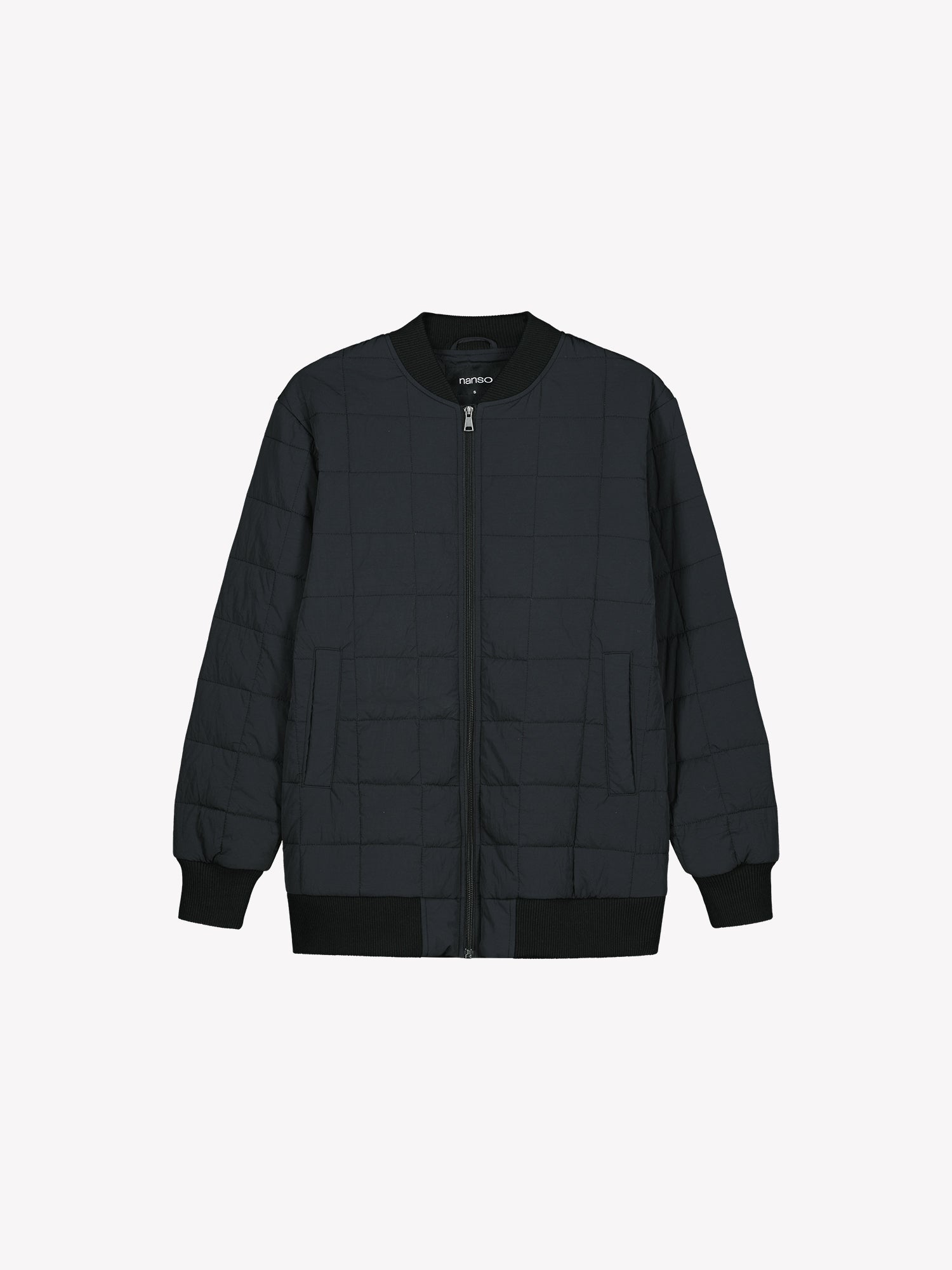 Nanso MERJE Quilted Bomber Jacket in Black features a lightweight Sorona -insulation, ribbed knit detailing at the neckline, cuffs, and hem. Dropped shoulders create a relaxed, contemporary silhouette. Product picture from the front.