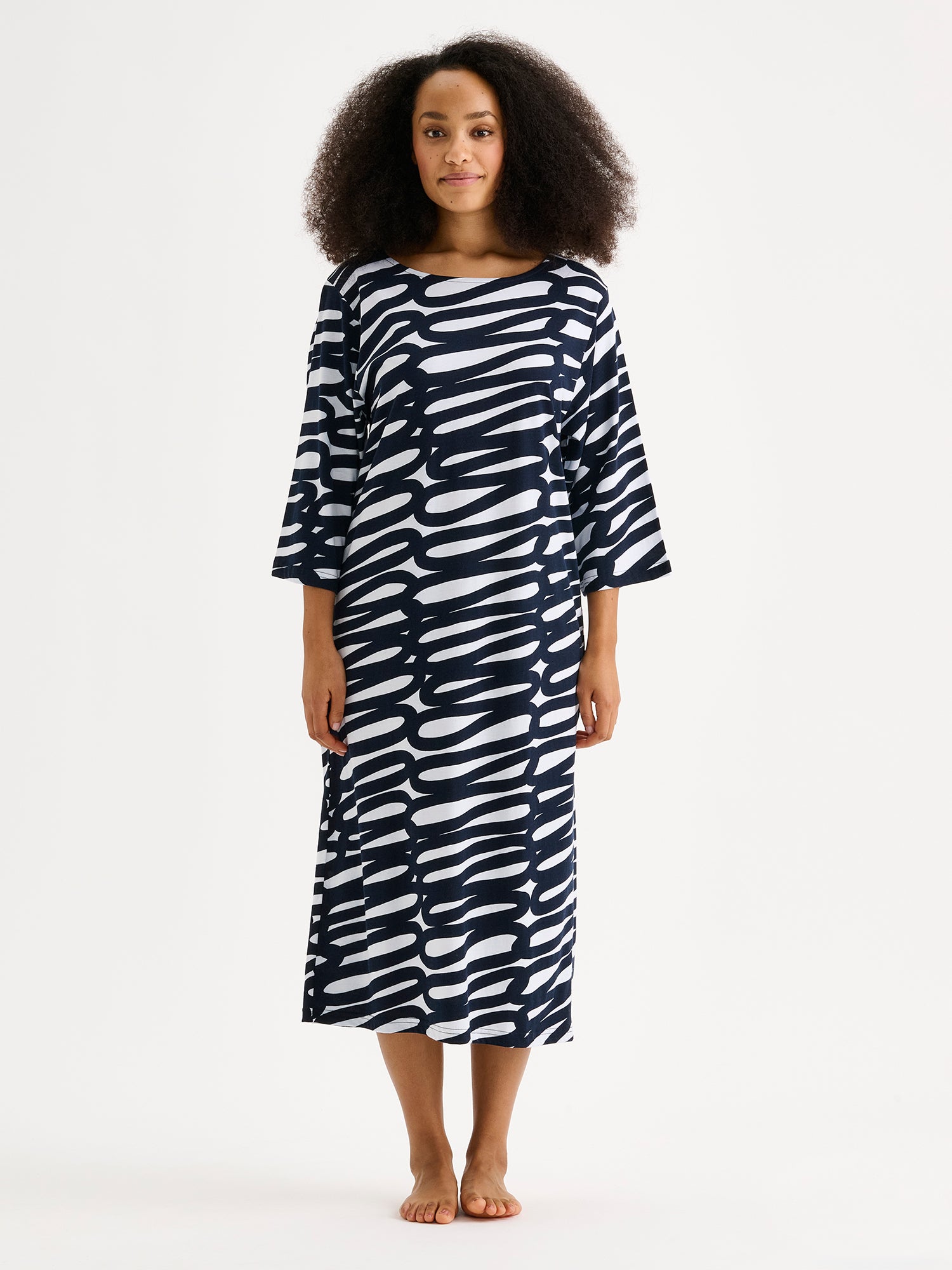 The LUONNOS Long Nightgown features an elegant two-tone print design that combines comfort with contemporary style. Pictured on a model.