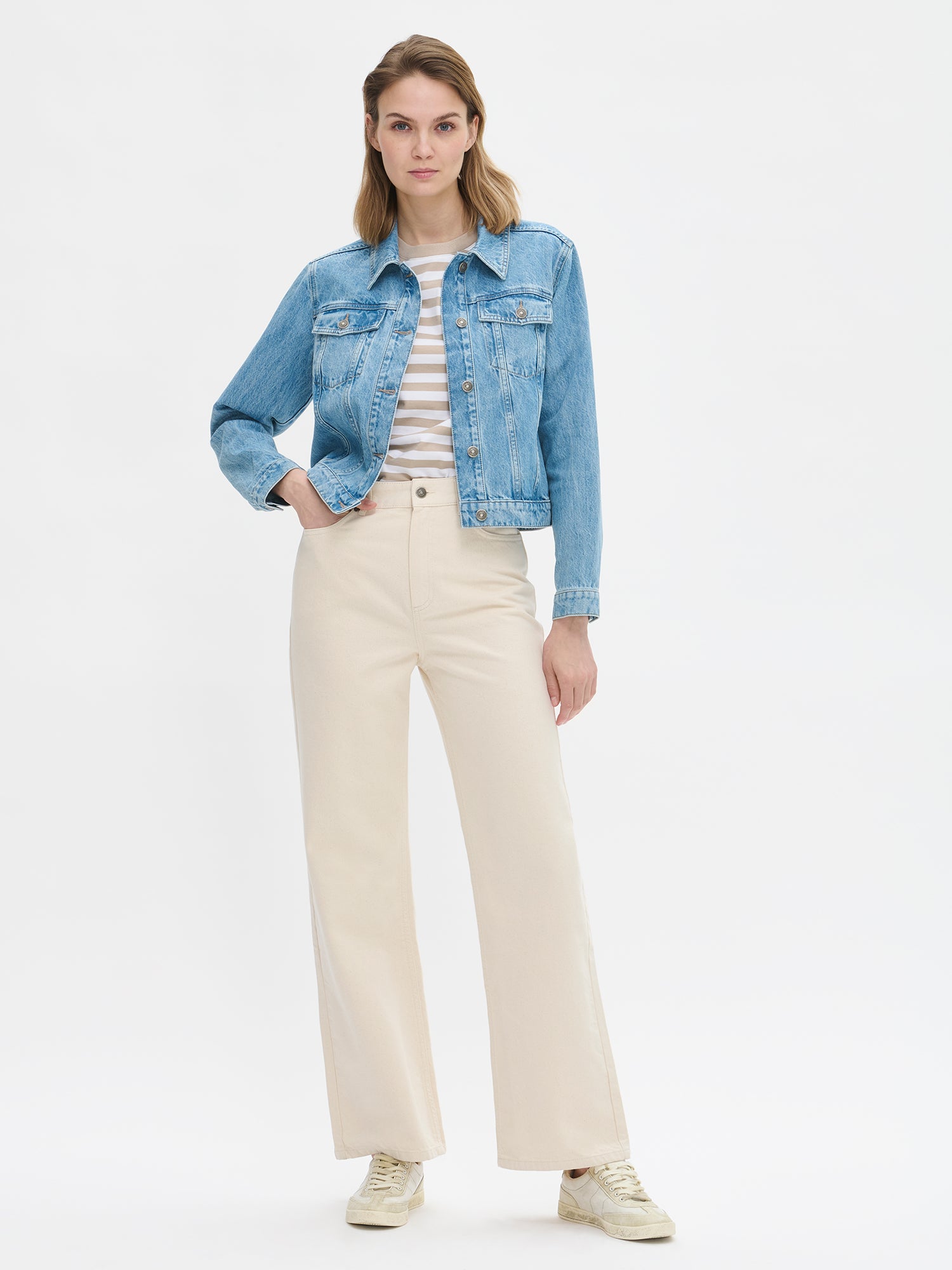 Nanso women’s off white Levee jeans with a high waist and wide flared legs, on a model from the front.