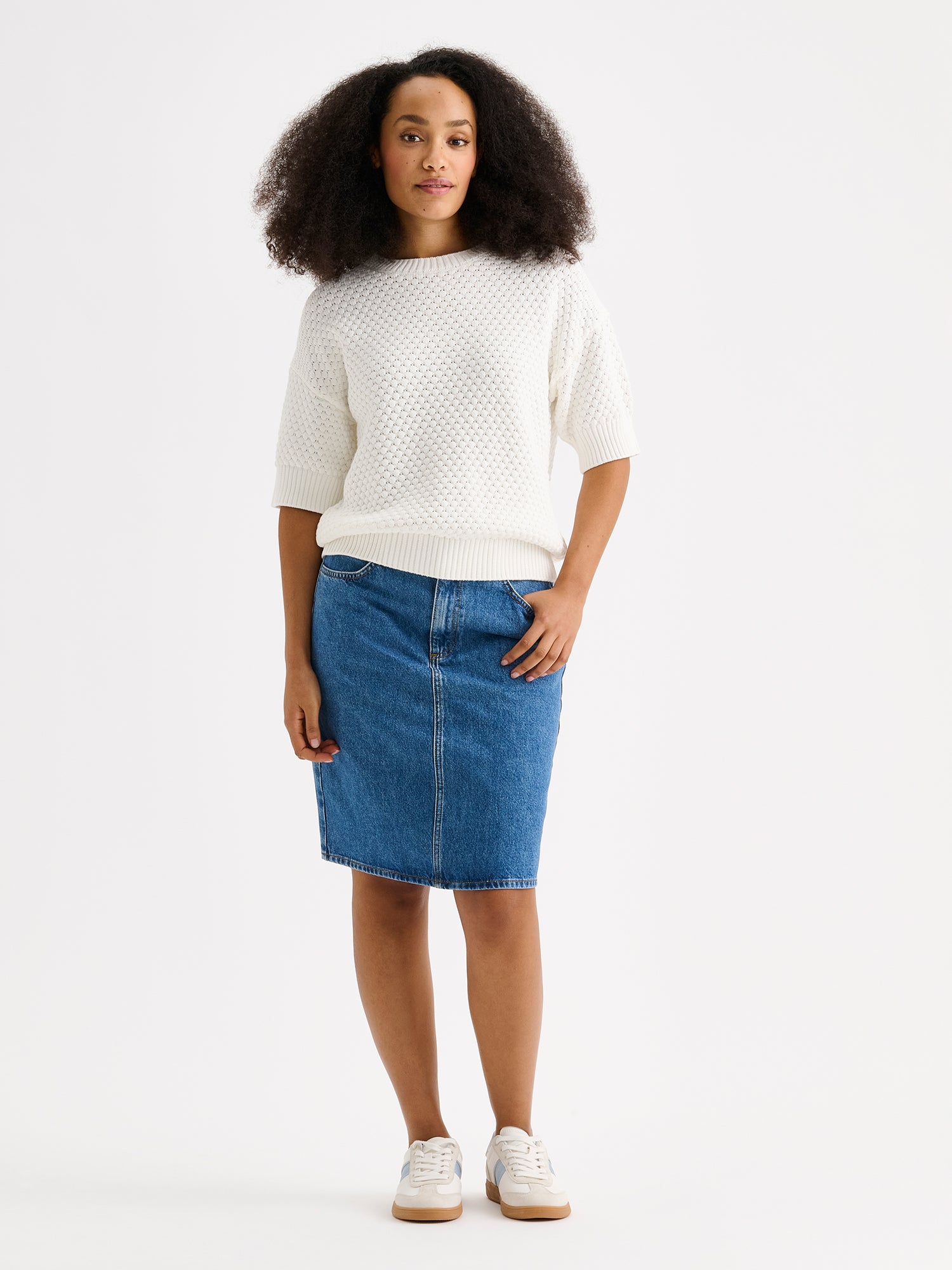 Nanso women's Kumpu versatile short-sleeved knit sweater in off white on a model with denim skirt