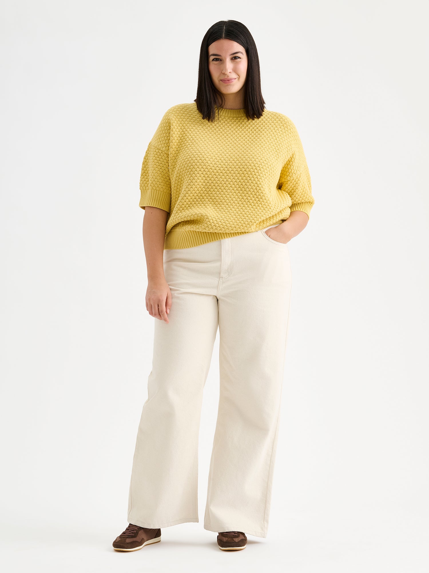 Nanso women's Kumpu versatile short-sleeved knit sweater in yellow on a model with light jeans