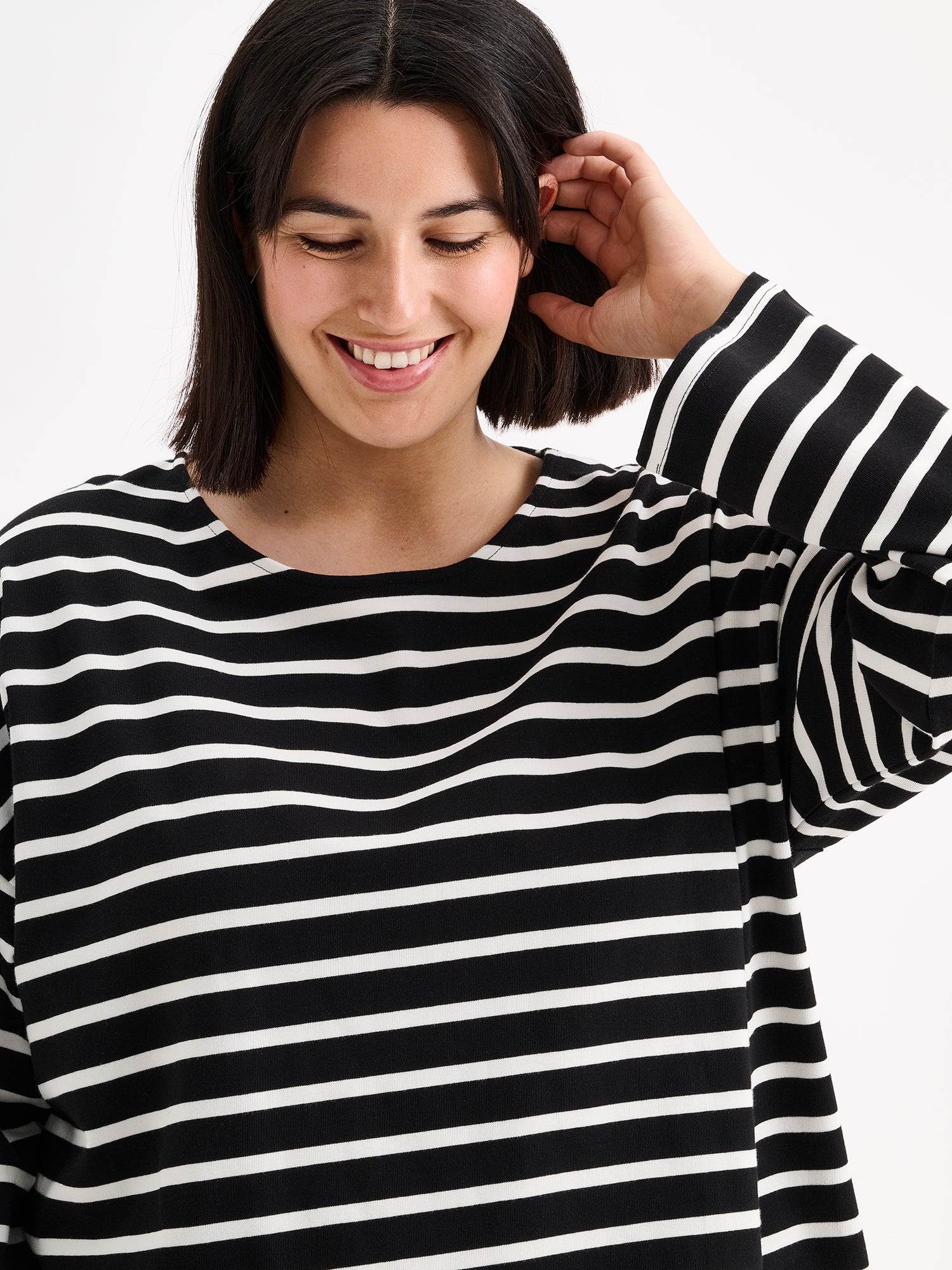 Nanso women's black and white striped long-sleeved Breton blouse with a relaxed, effortless fit, on a model close-up.