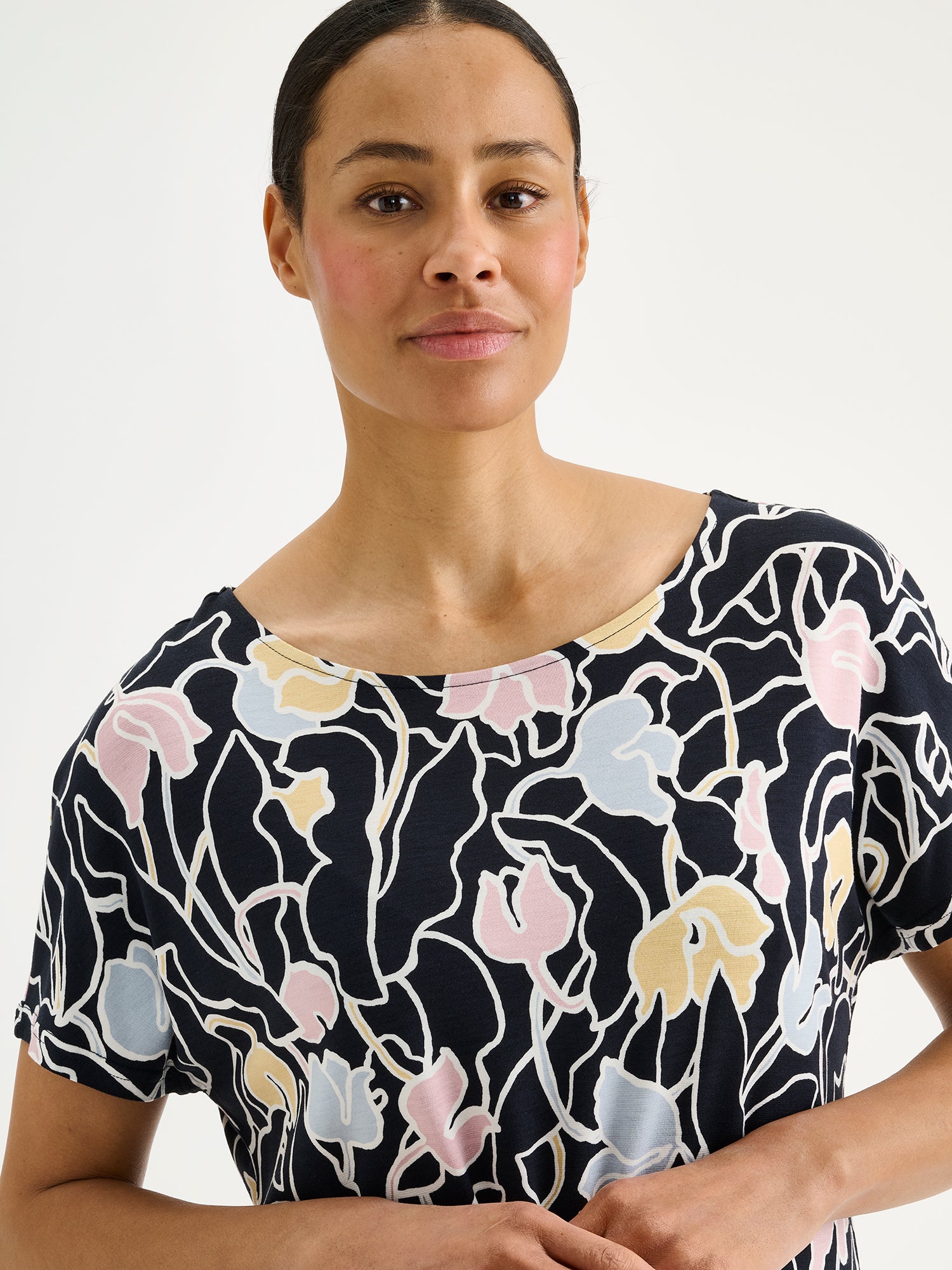 Nanso IIRIS Jersey Tunic - Elegant floral design in soft, breathable viscose jersey on a model close-up.