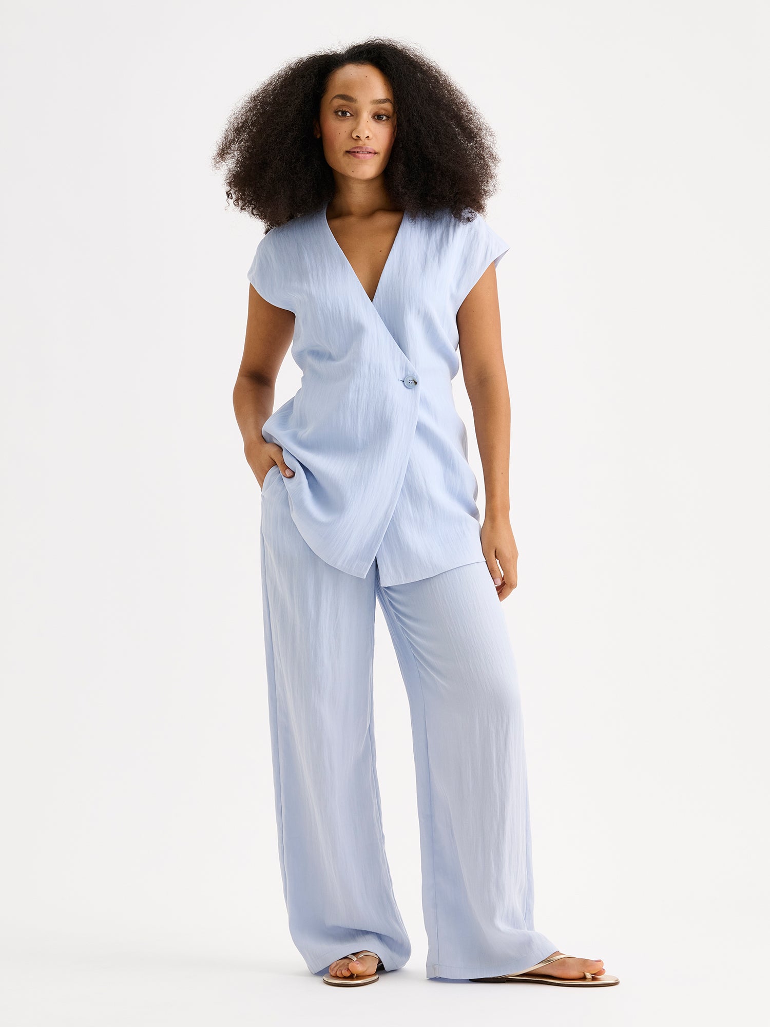 Nanso sophisticated blue waistcoat from the NIZZA collection on a model with matching trousers.