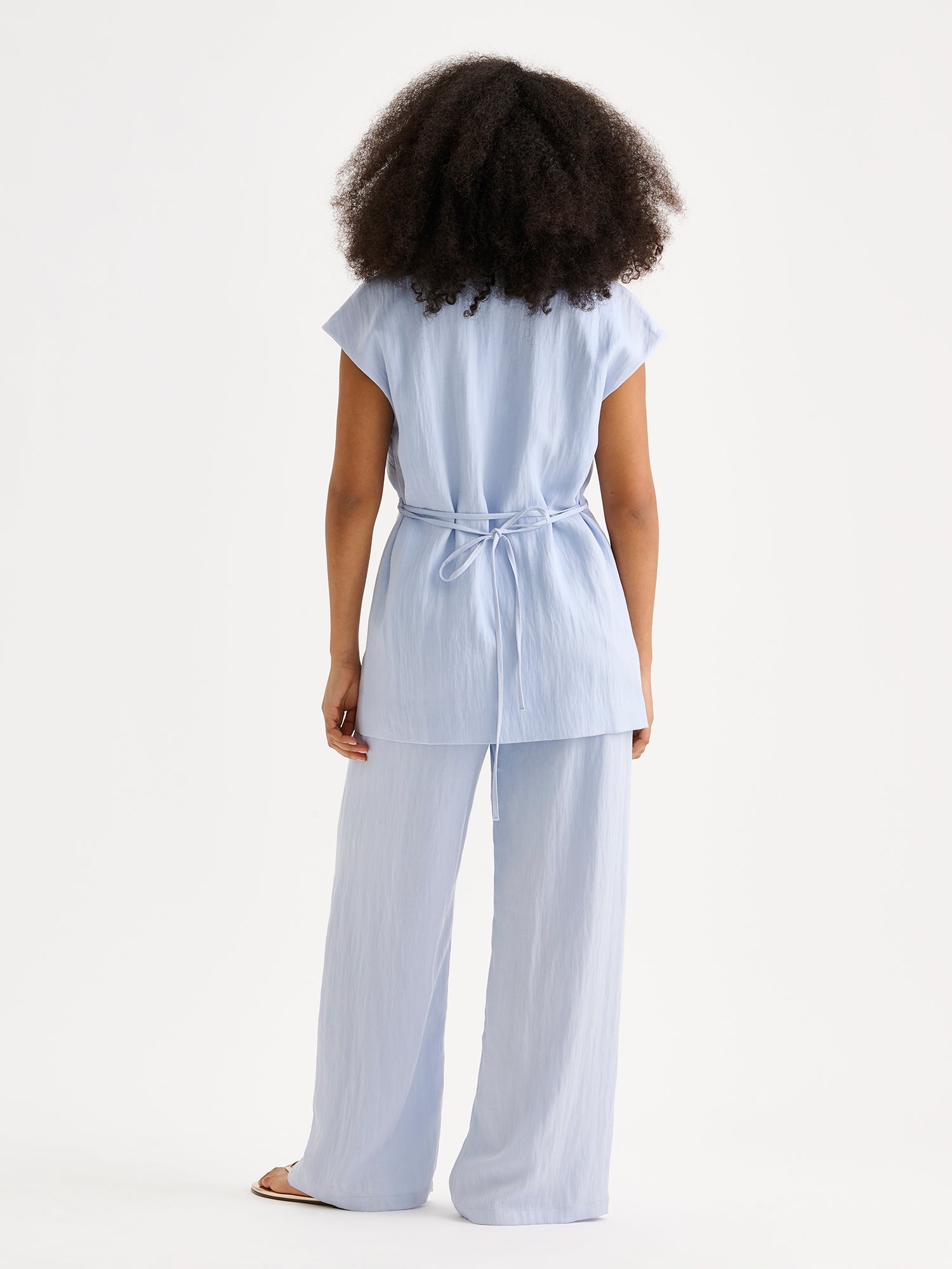 Nanso sophisticated blue waistcoat from the NIZZA collection on a model with matching trousers.