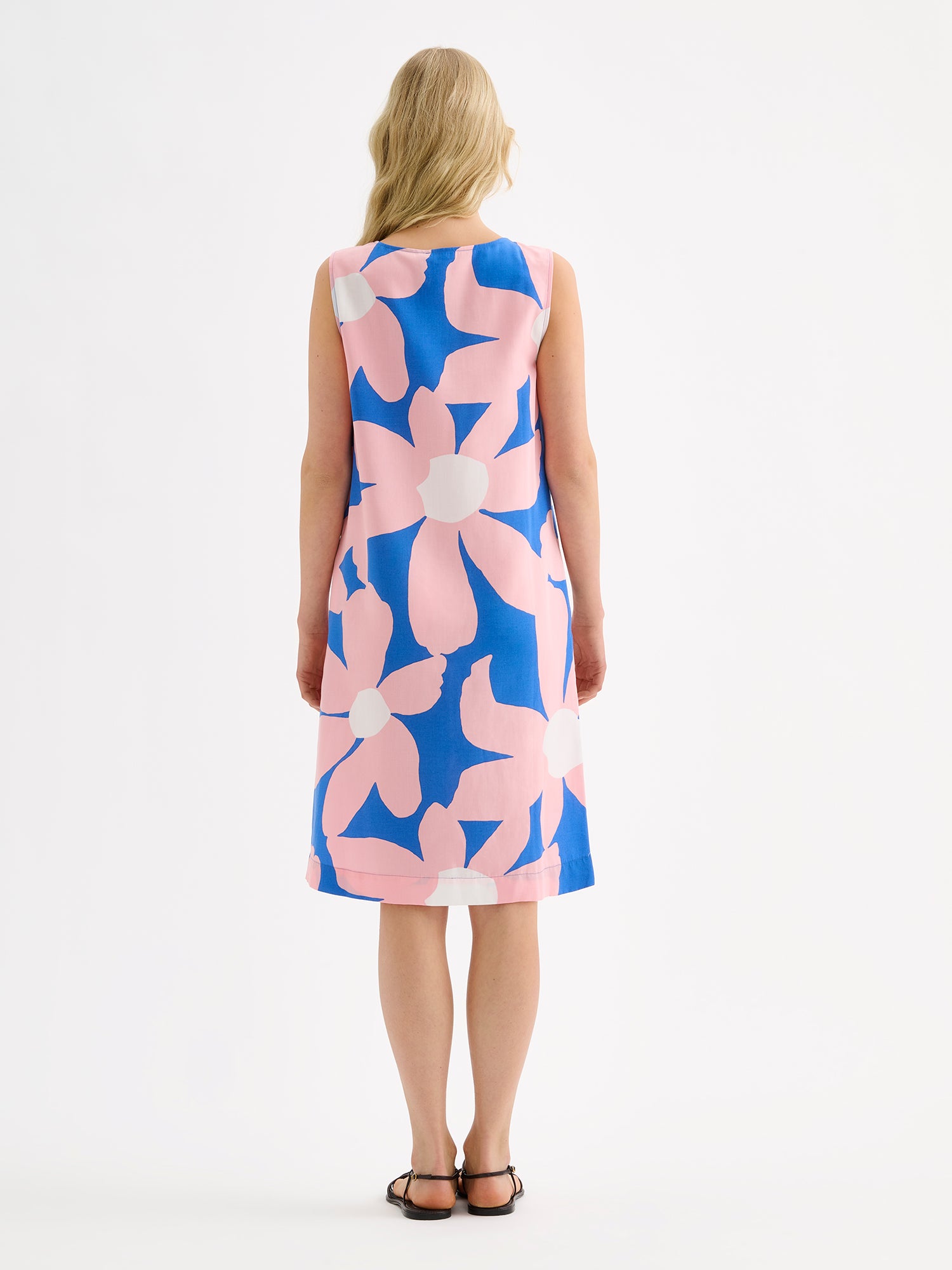 Nanso women's patterned sleeveless ROSI dress on a model pictured from the backside.