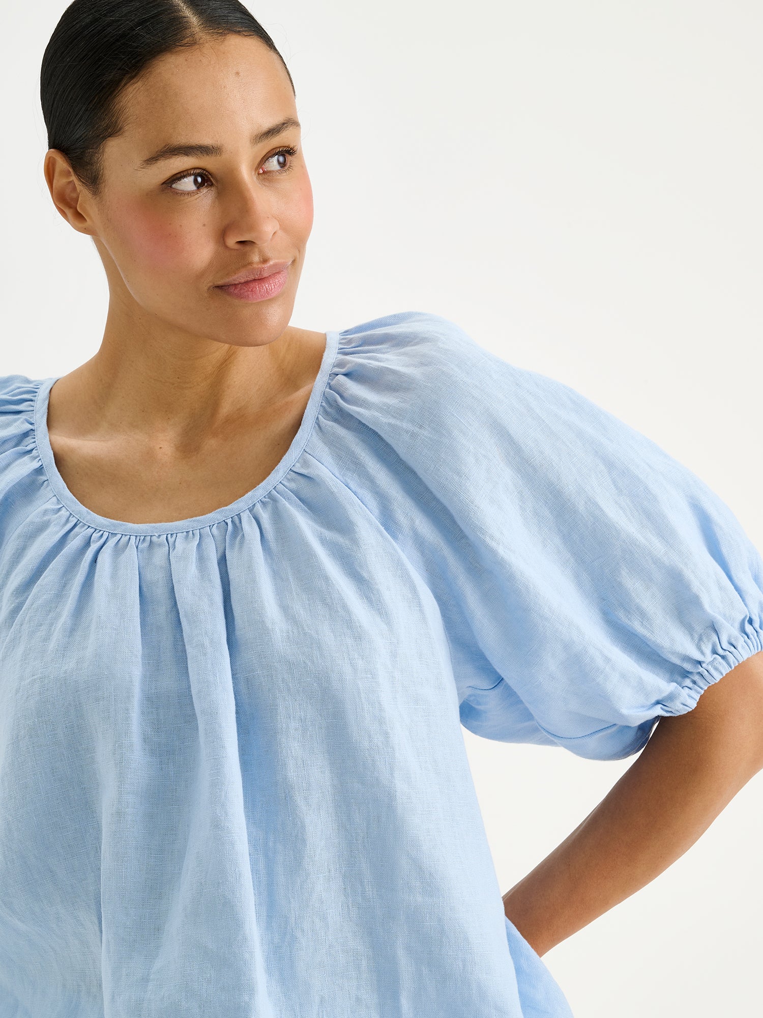Nanso women's Donna linen blouse in a light blue shade on a model, close-up.
